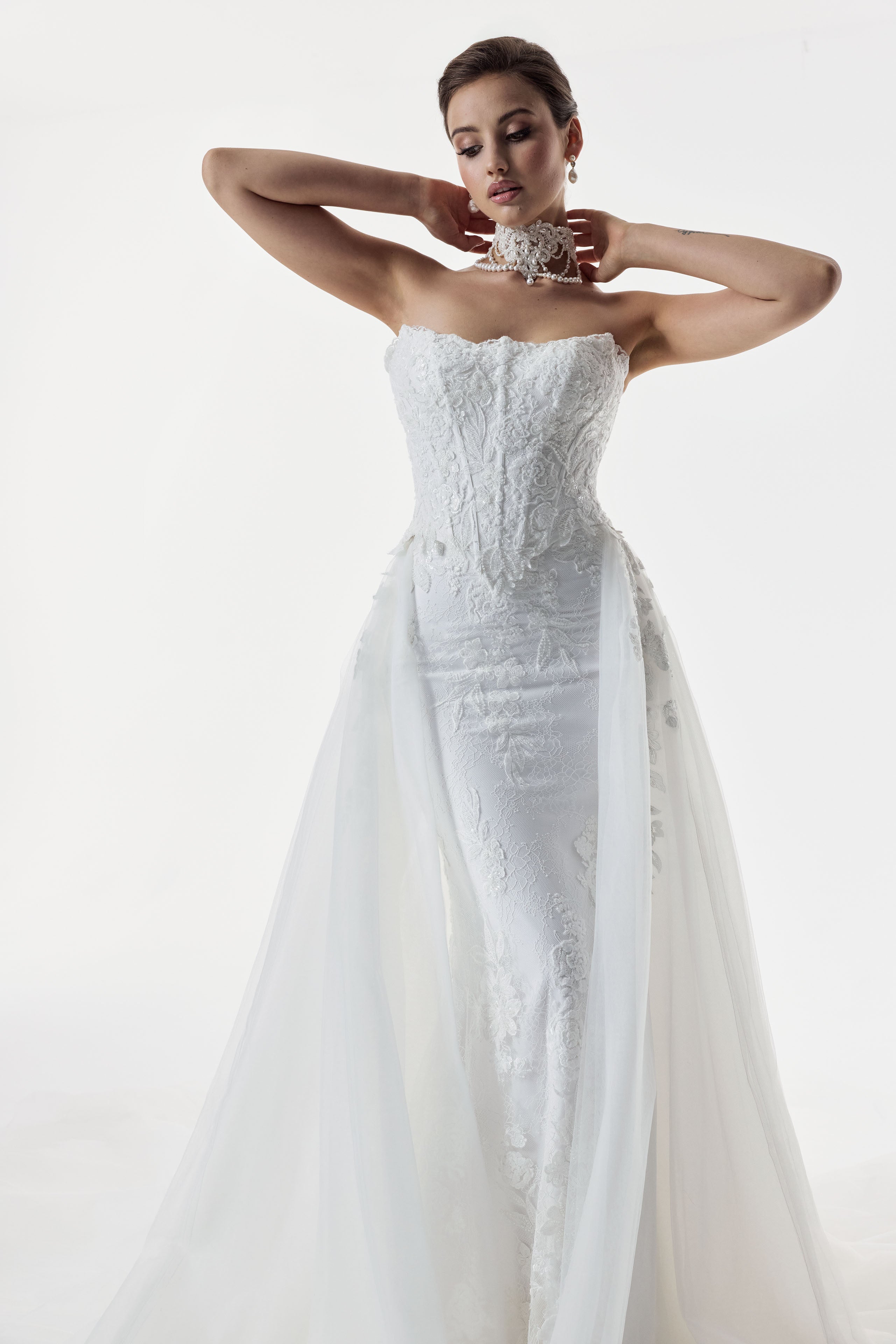 strapless scoop neckline embellished lace applique layered over Chantilly lace corset bodice basque waist with a detachable fitted skirt and choker