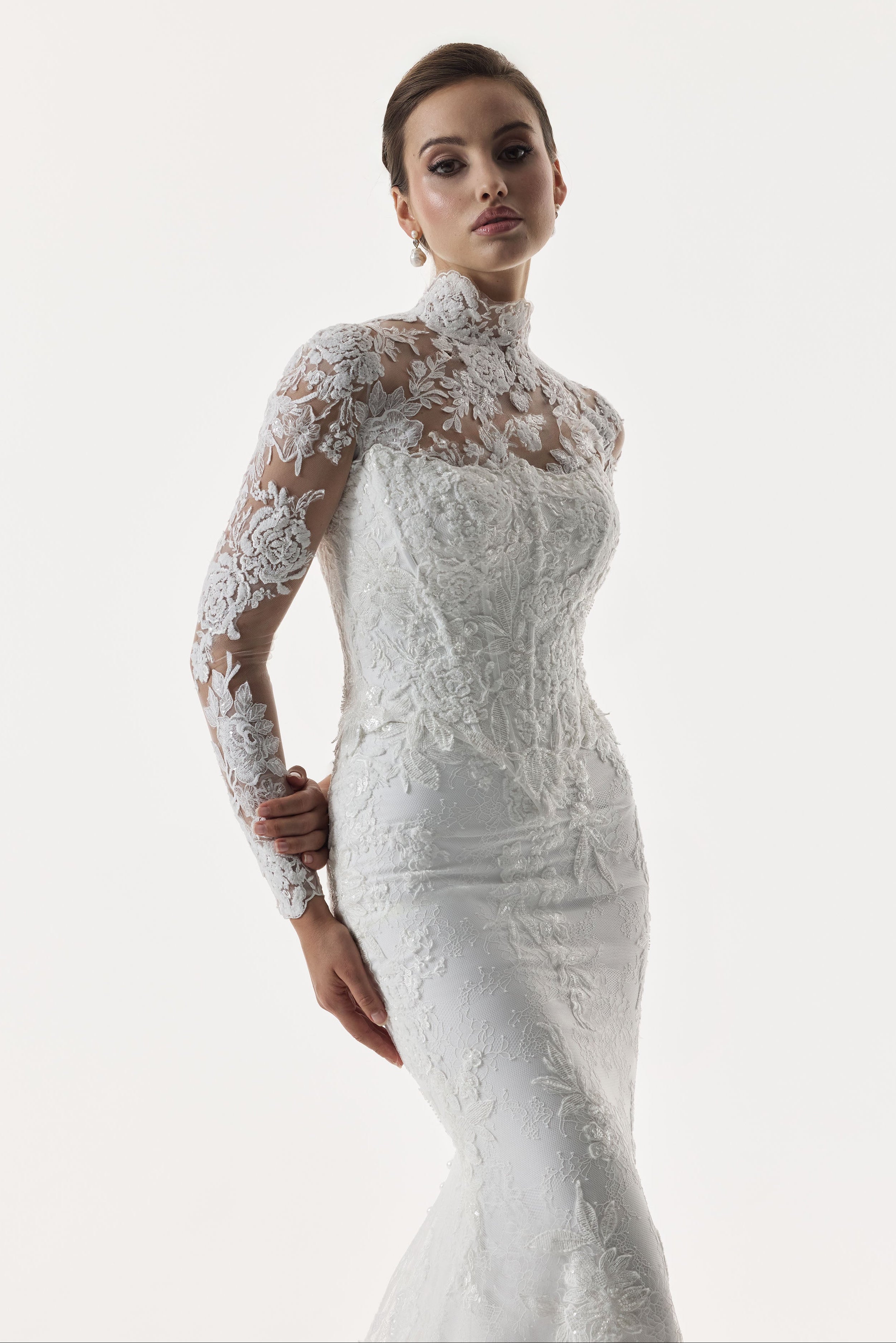 strapless scoop neckline embellished lace applique layered over Chantilly lace corset bodice basque waist with a detachable fitted skirt and high neck long sleeve lace topper