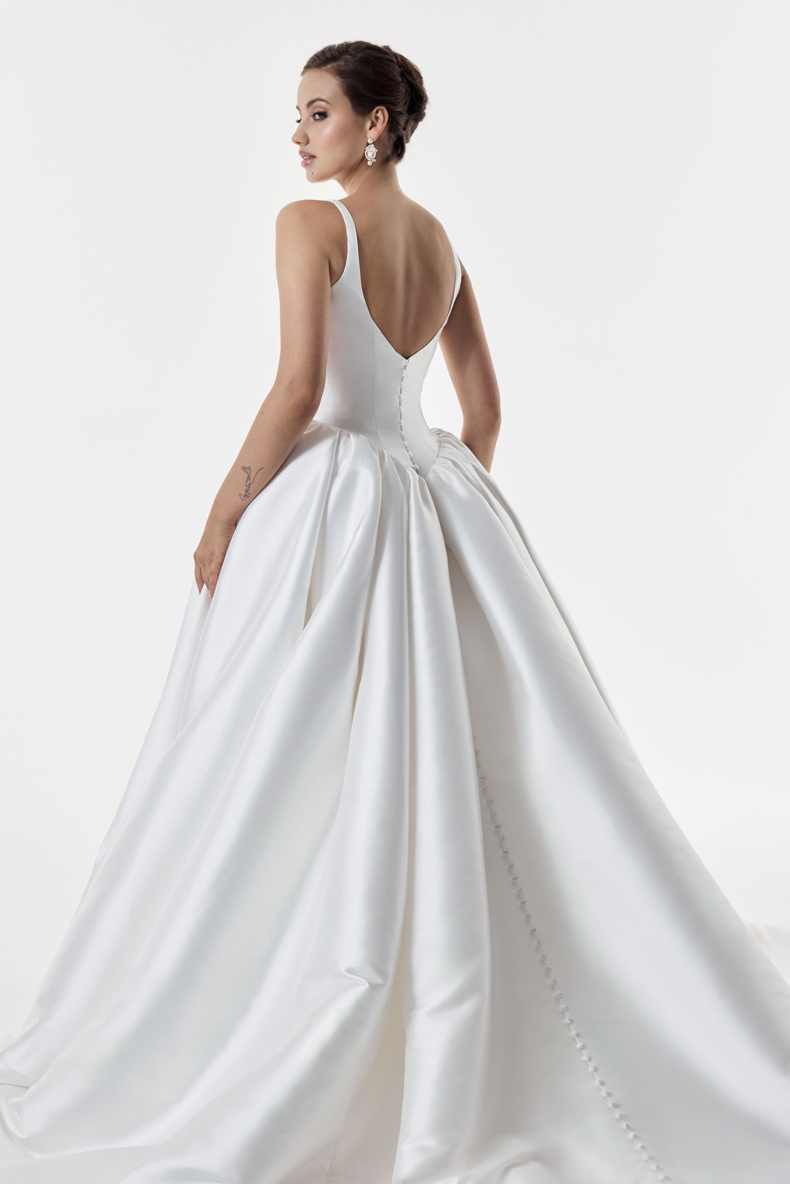 square and scoop strap neckline with a flattering basque waist corset and ballgown A-line skirt with low back and pearl buttons