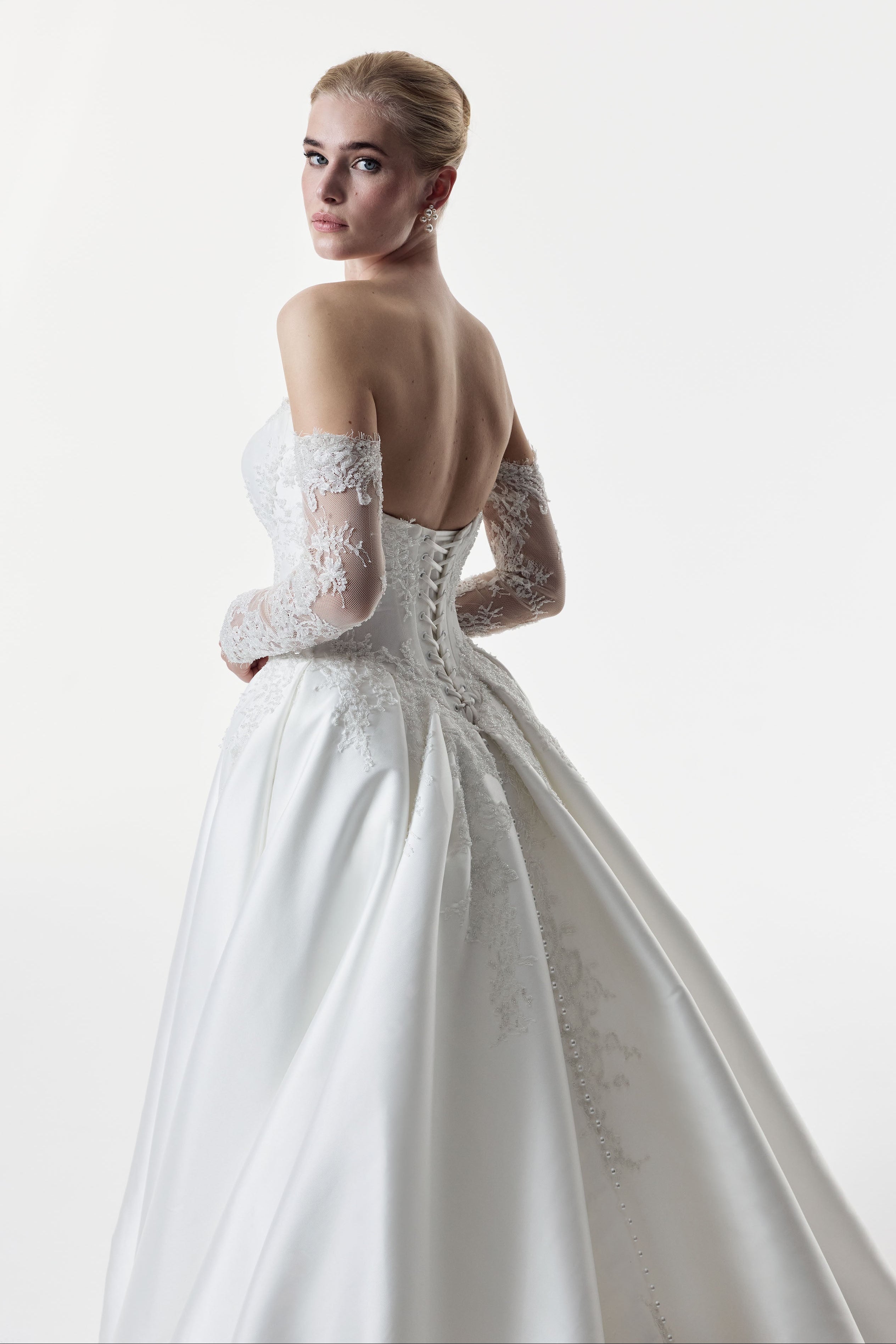 sweetheart neckline with silk Mikado and beaded lace with a basque waist corset and full A-line ballgown skirt with matching lace sleeves