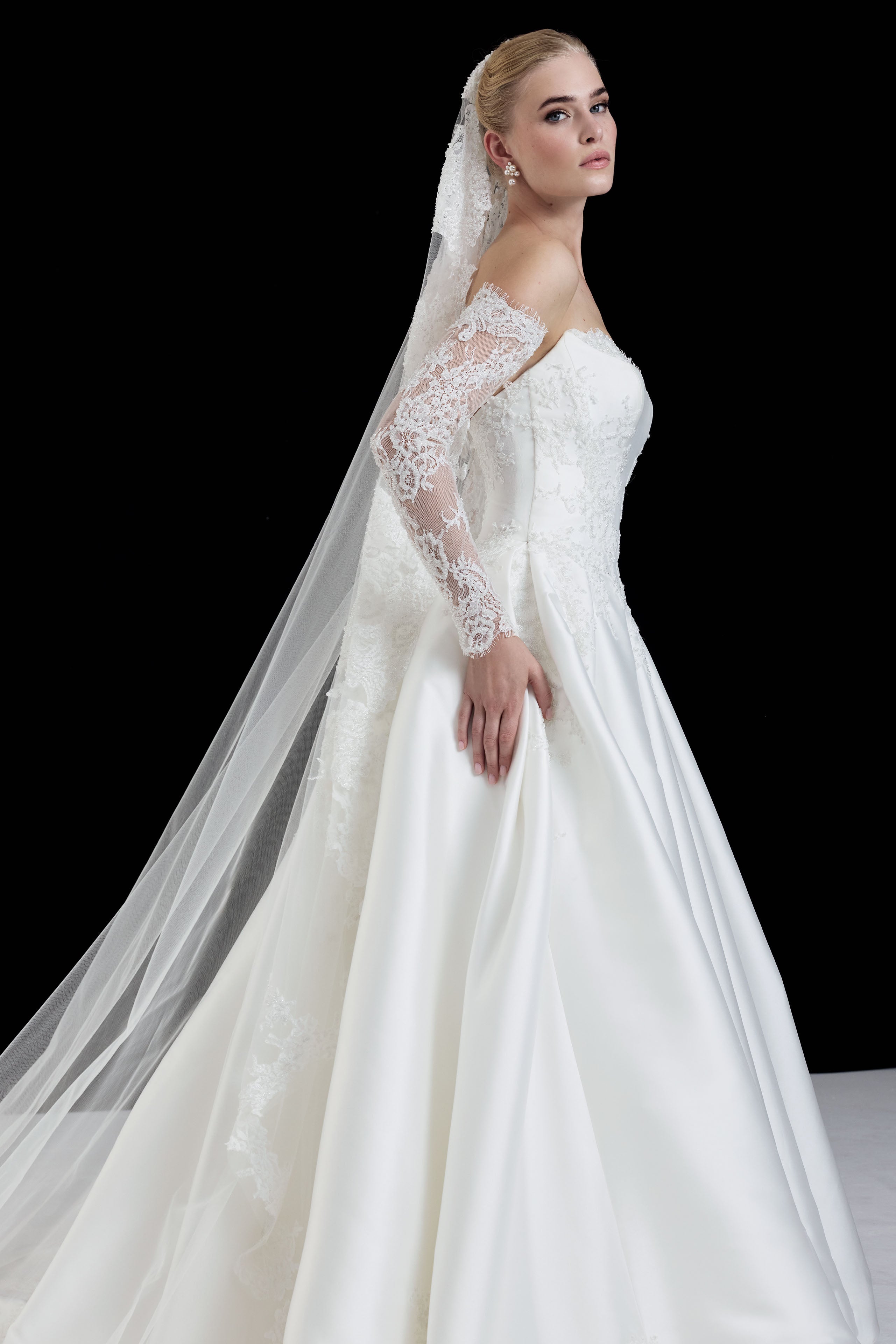 sweetheart neckline with silk Mikado and beaded lace with a basque waist corset and full A-line ballgown skirt with matching detachable sleeves and veil