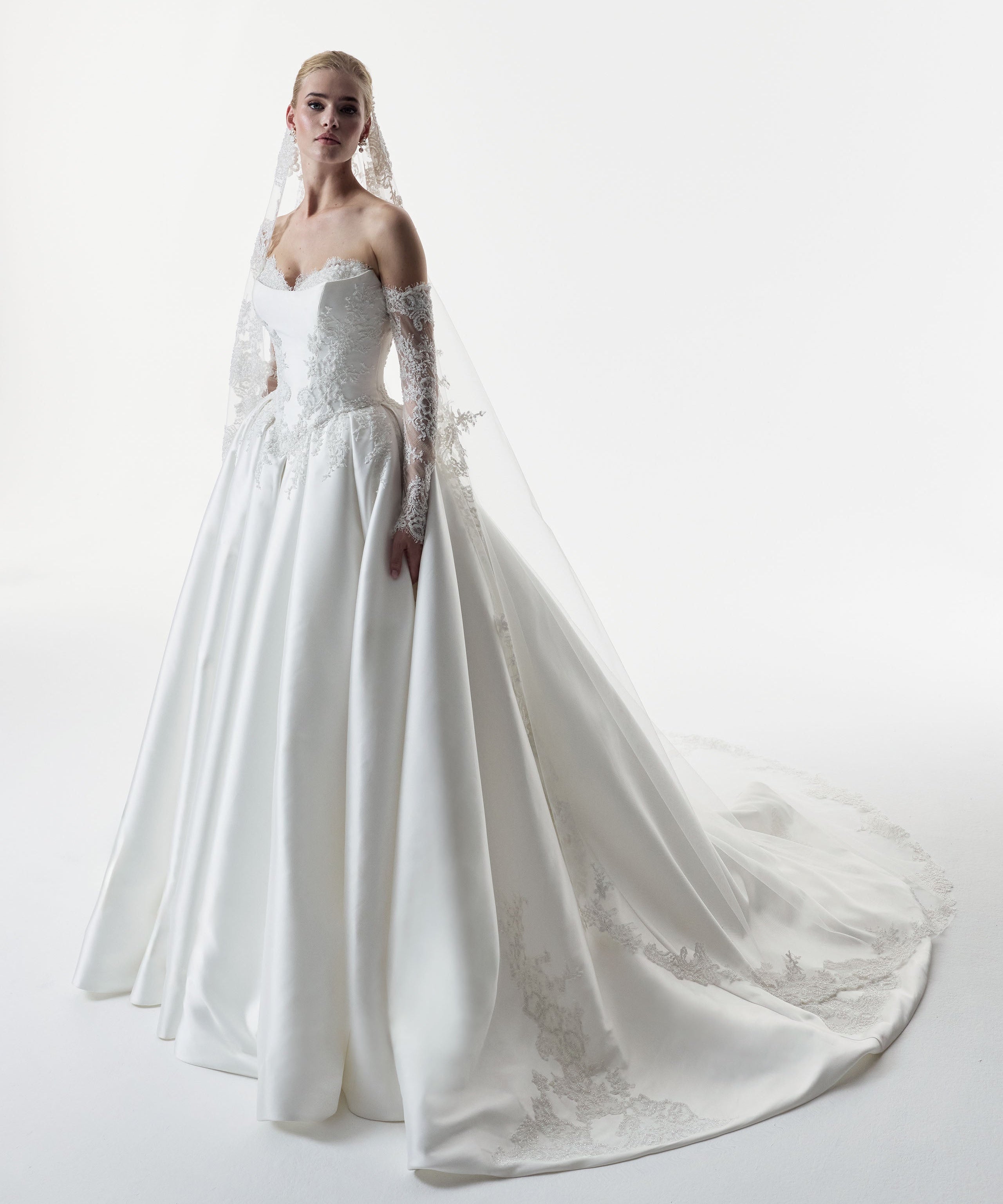 sweetheart neckline with silk Mikado and beaded lace with a basque waist corset and full A-line ballgown skirt with matching detachable sleeves and lace veil