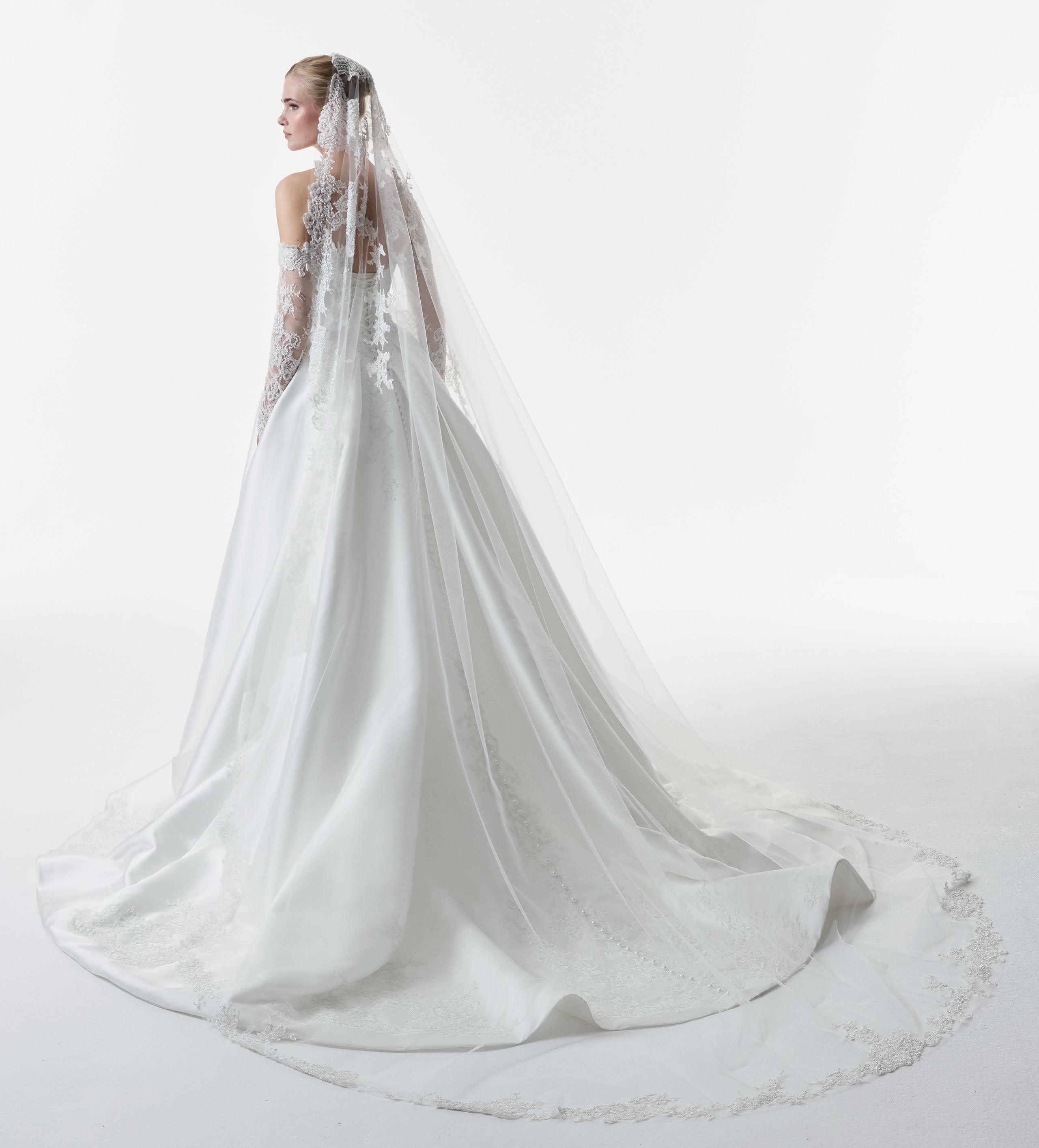 sweetheart neckline with silk Mikado and beaded lace with a basque waist corset and full A-line ballgown skirt with matching detachable sleeves and lace veil
