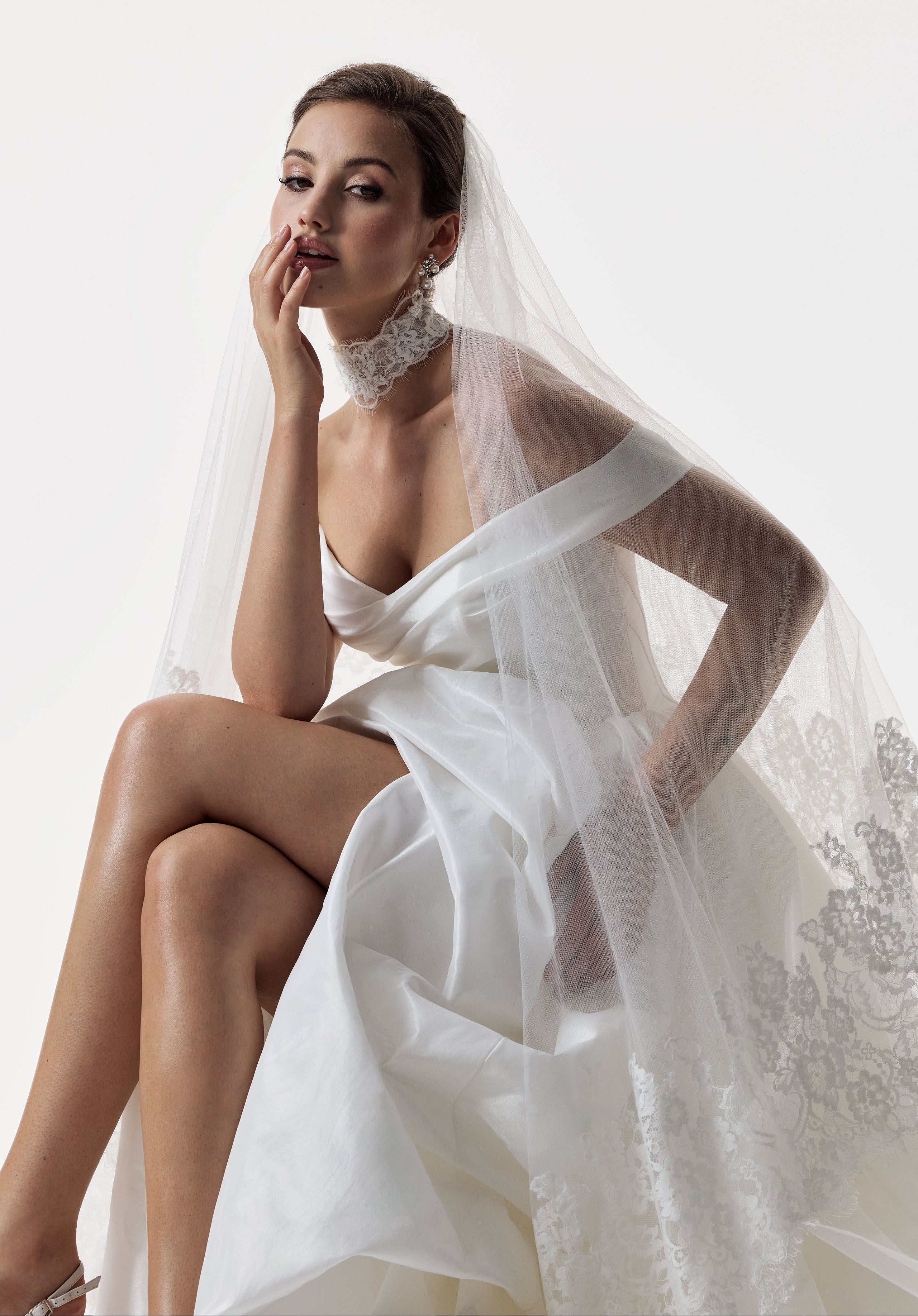 classic ivory bardot neckline and corset basque waist and ruched pick-up skirt leg slit detailing