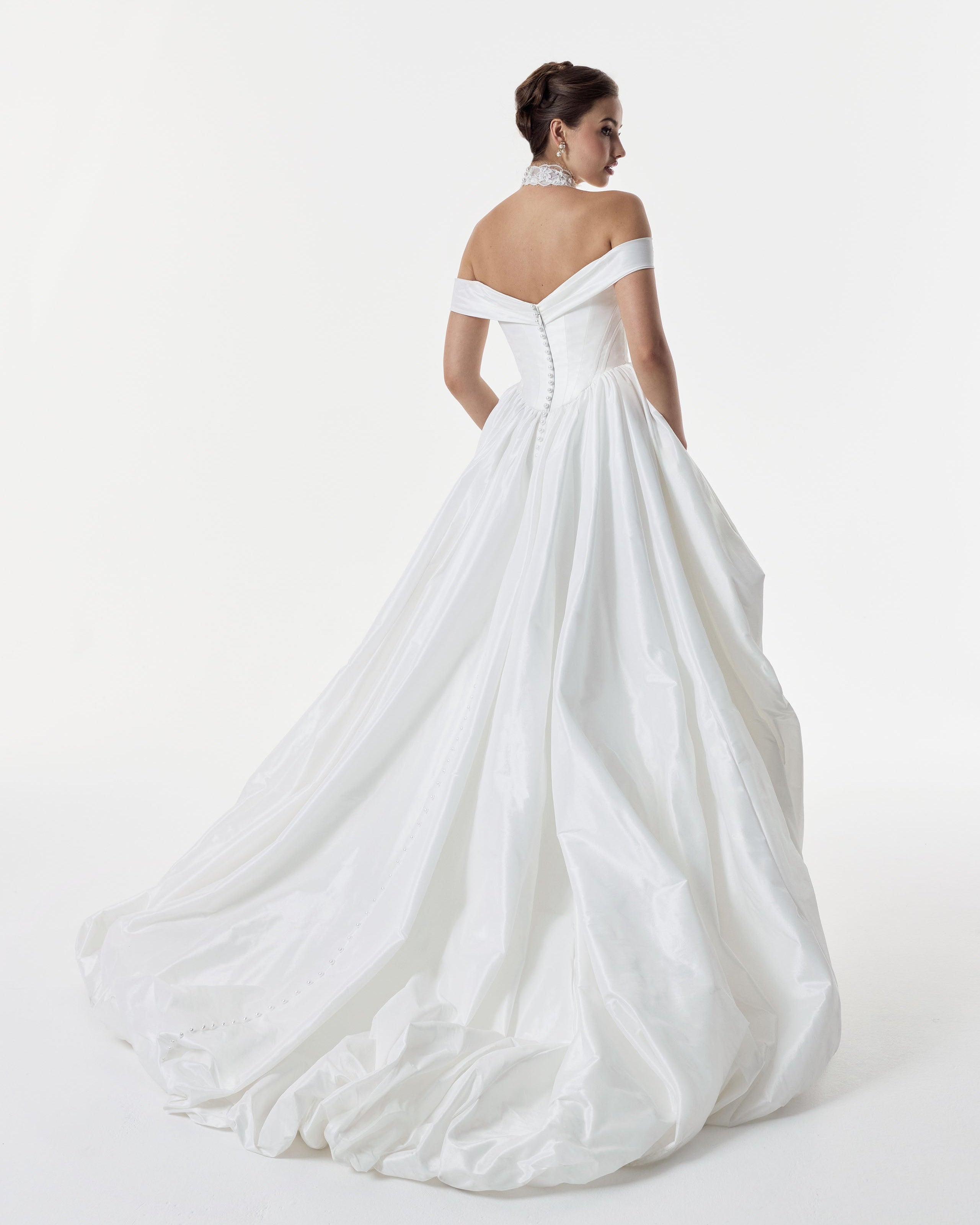 classic ivory bardot neckline and corset basque waist and ruched pick-up skirt leg slit detailing and pearl buttons