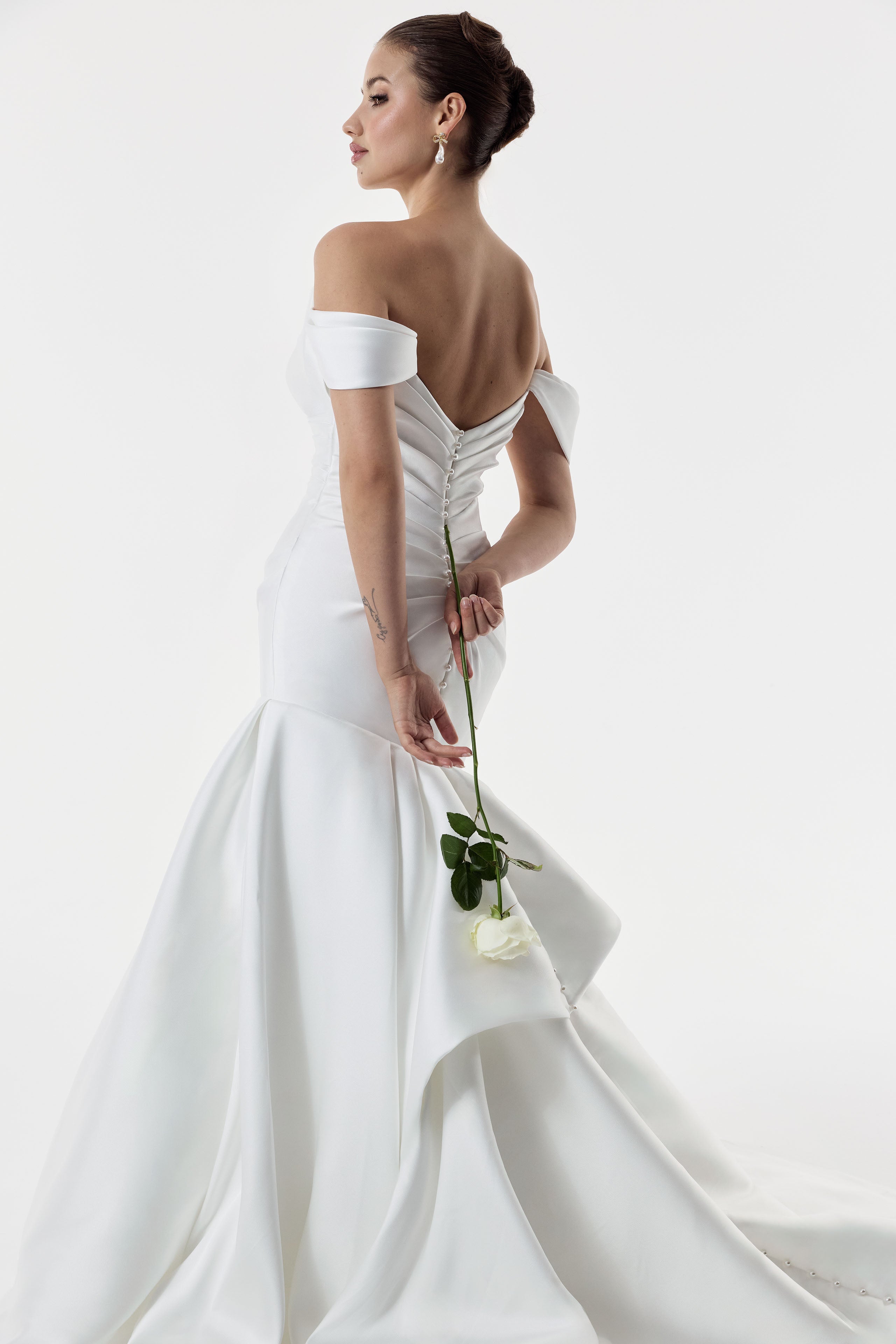 cat eye sweetheart neckline with dropped straps and Mikado pleated fitted mermaid dress with ruched back and pearl buttons