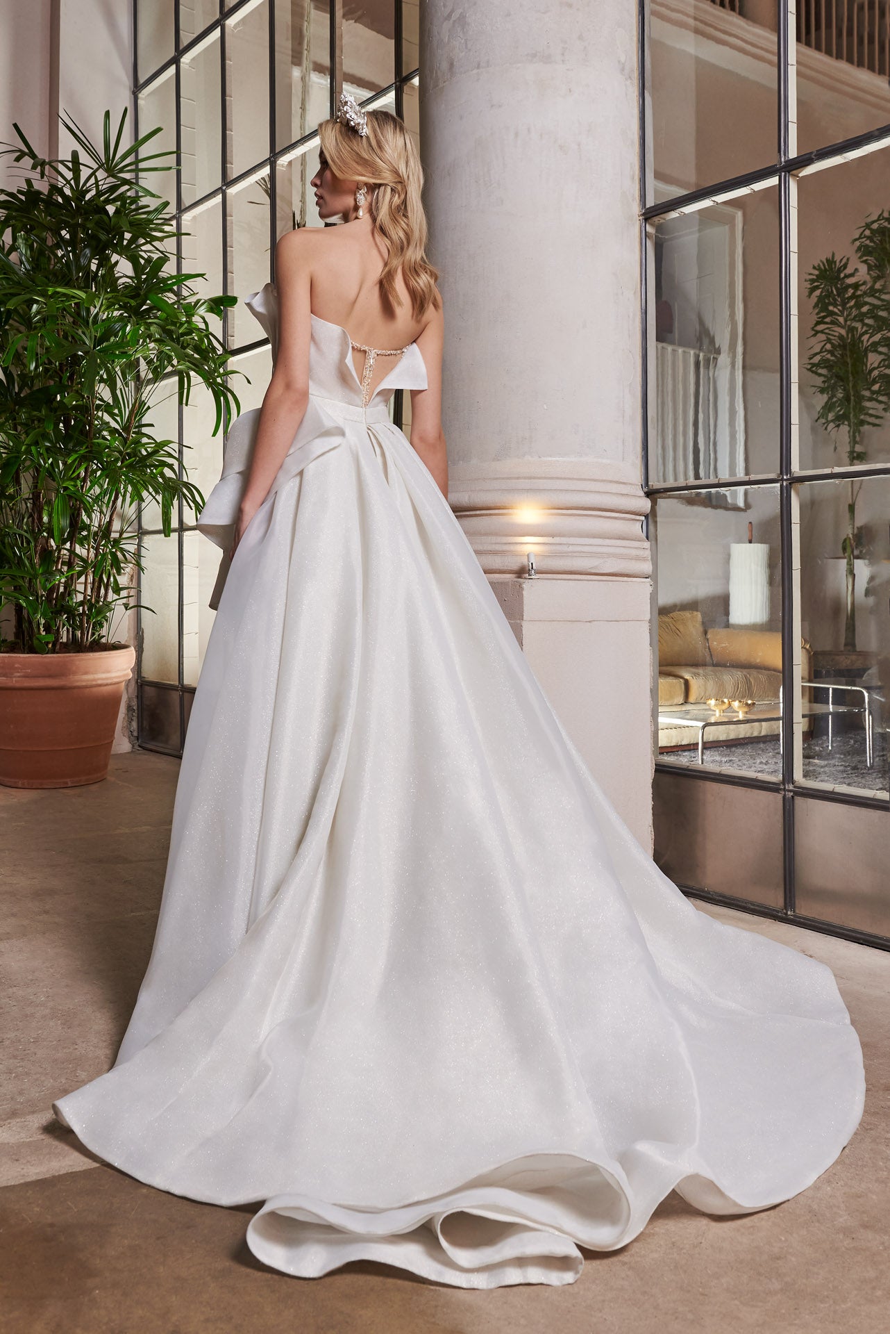 Ballgown of organza and crystal mesh ruffles and pleats with skirt opening. Embellished Pearl and crystal encrusted, illusion corset.