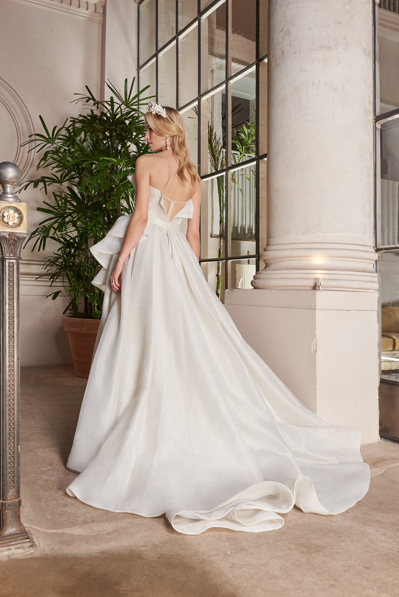 Ballgown of organza and crystal mesh ruffles and pleats with skirt opening. Embellished Pearl and crystal encrusted, illusion corset.