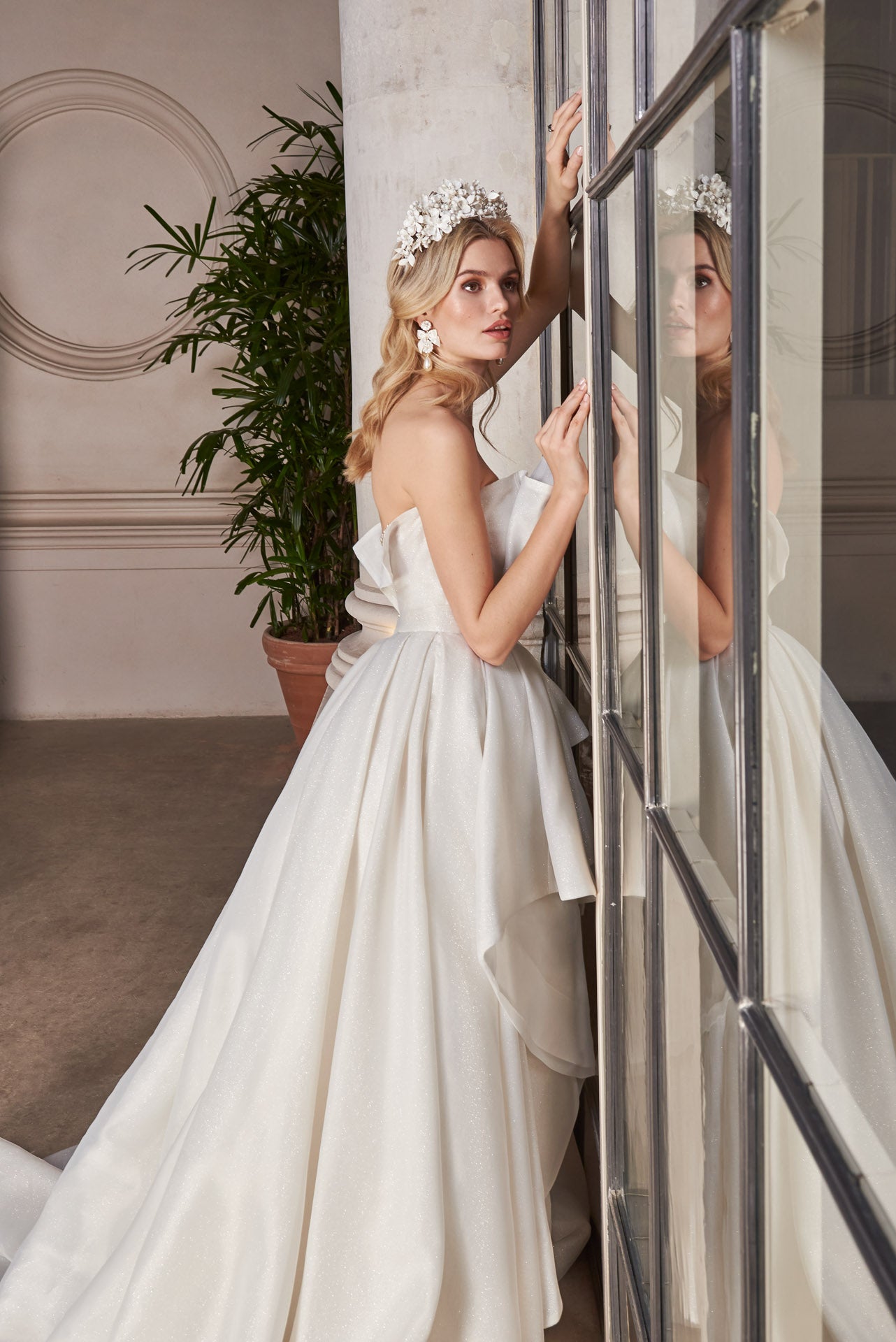 Ballgown of organza and crystal mesh ruffles and pleats with skirt opening. Embellished Pearl and crystal encrusted, illusion corset.