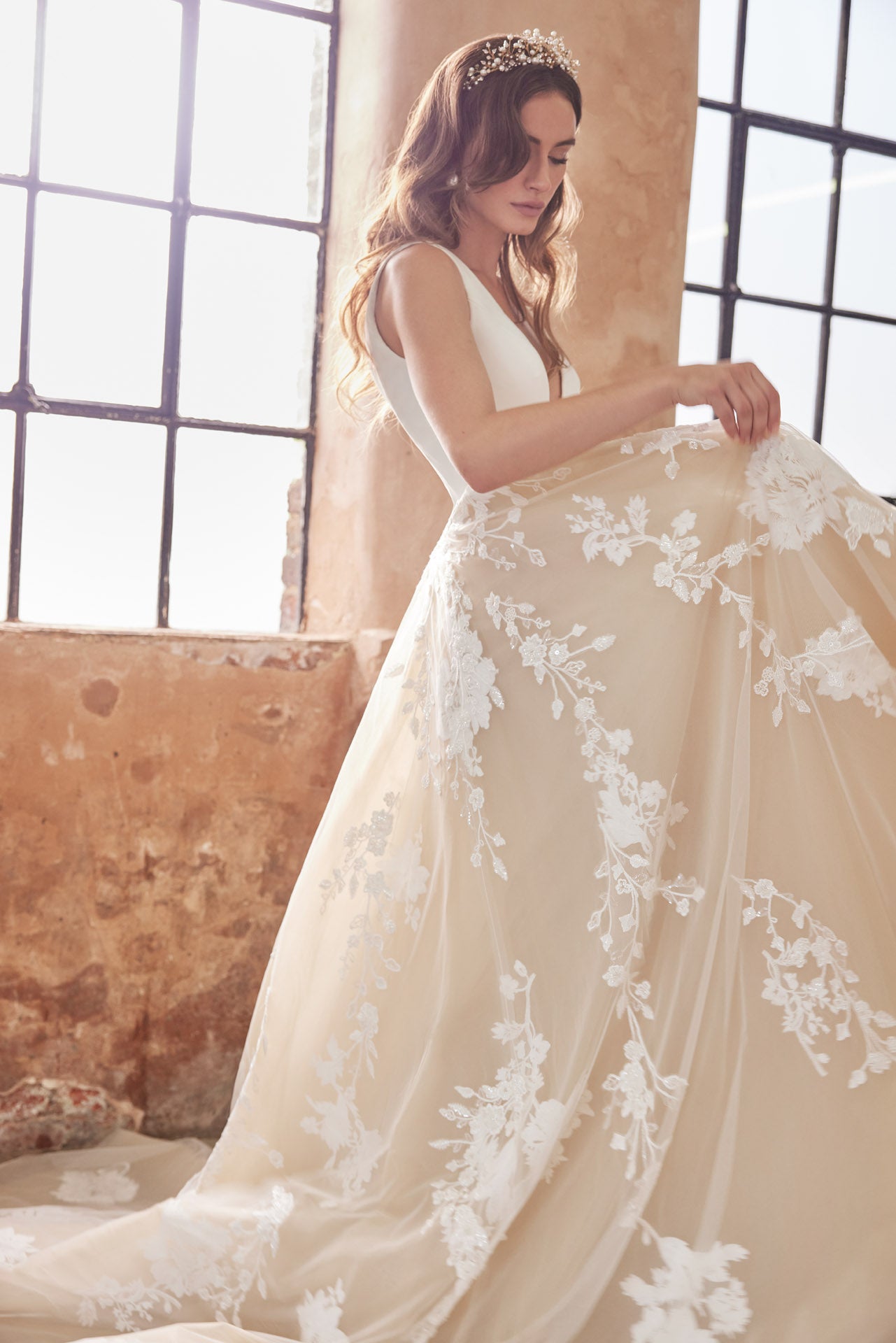 Ballgown with soft layers of tulle and floral applique lace on skirt, crepe v-neck bodice and key-hole back.