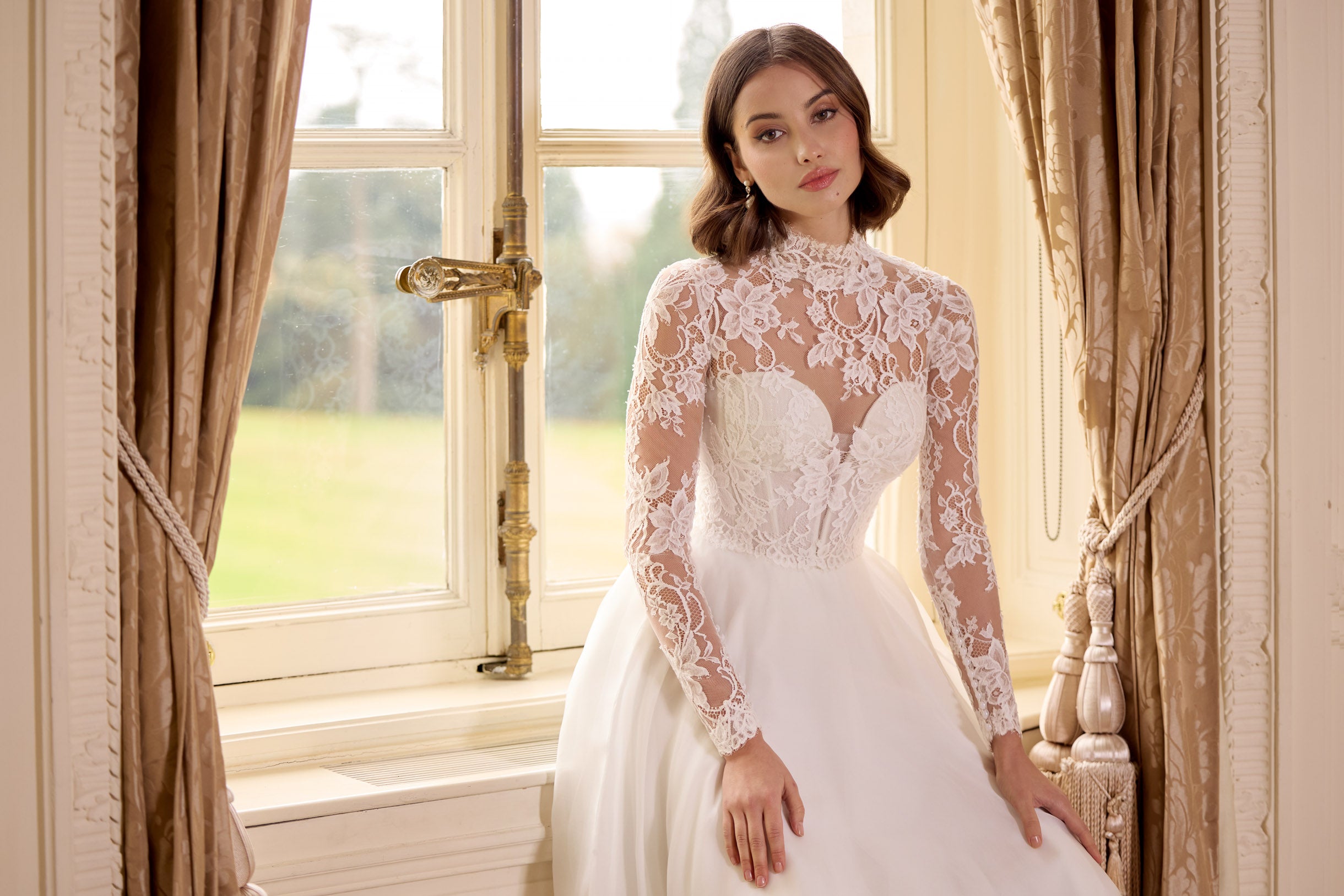 high neck, sweetheart neckline long sleeved lace corset bodice with a flattering plunge neckline and button back with a silk organza A-line skirt