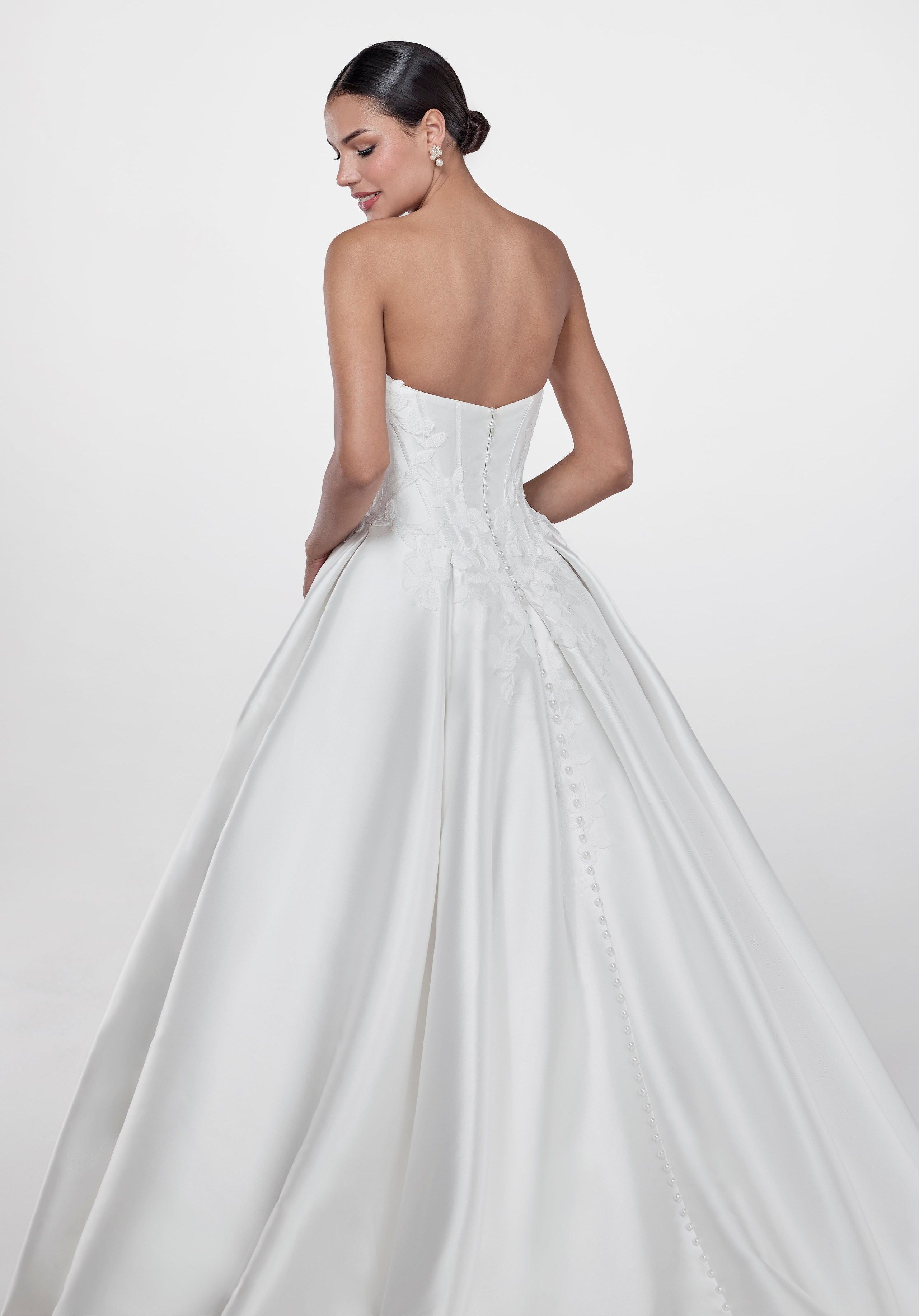 Strapless cat eye neckline with V basque dropped waist corset and A-line skirt with floral embroidered lace applique