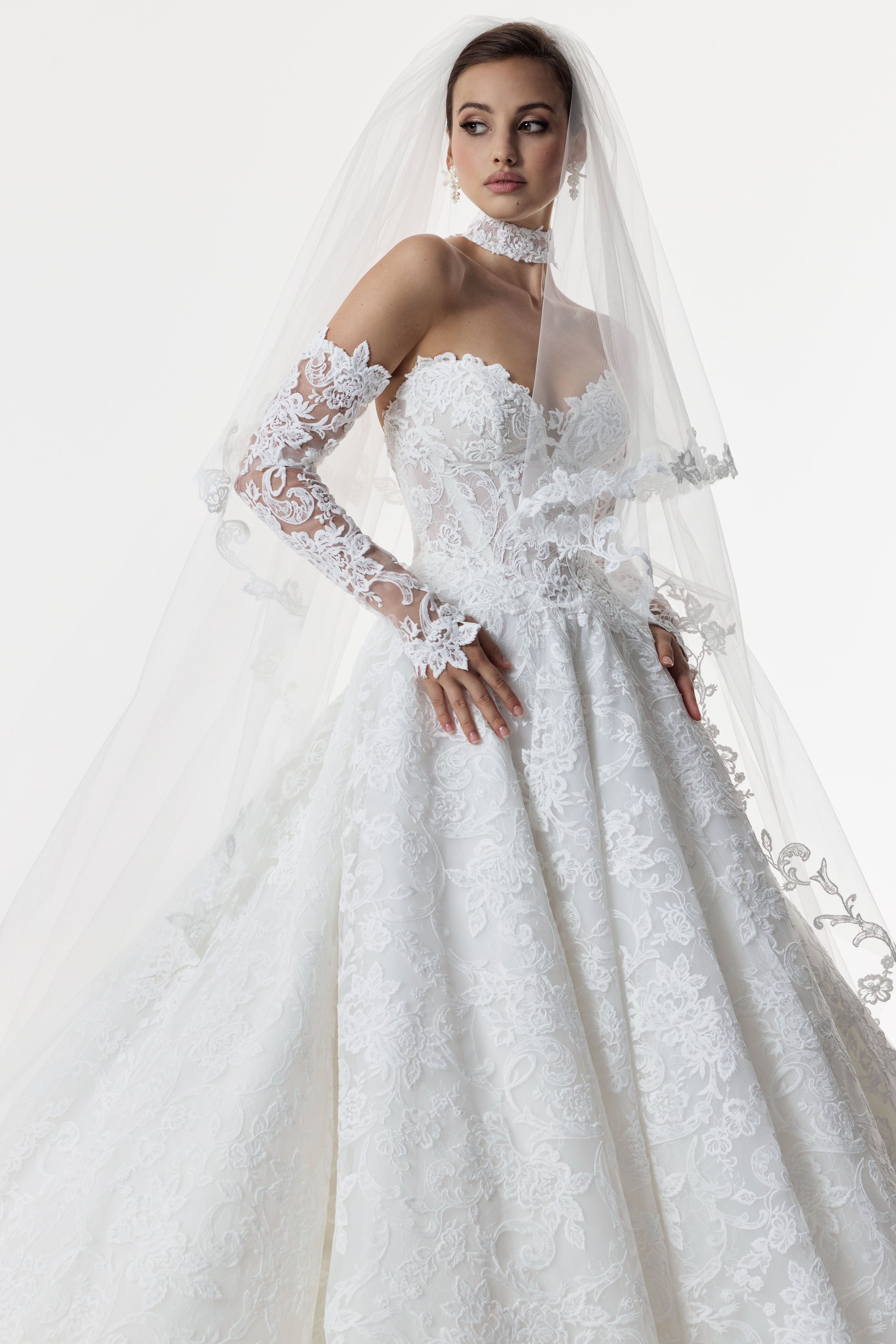 strapless sweetheart neckline corset A-line dress with embroidered lace layered over delicate Chantilly lace with matching lace choker and lace sleeves and double tier wedding veil