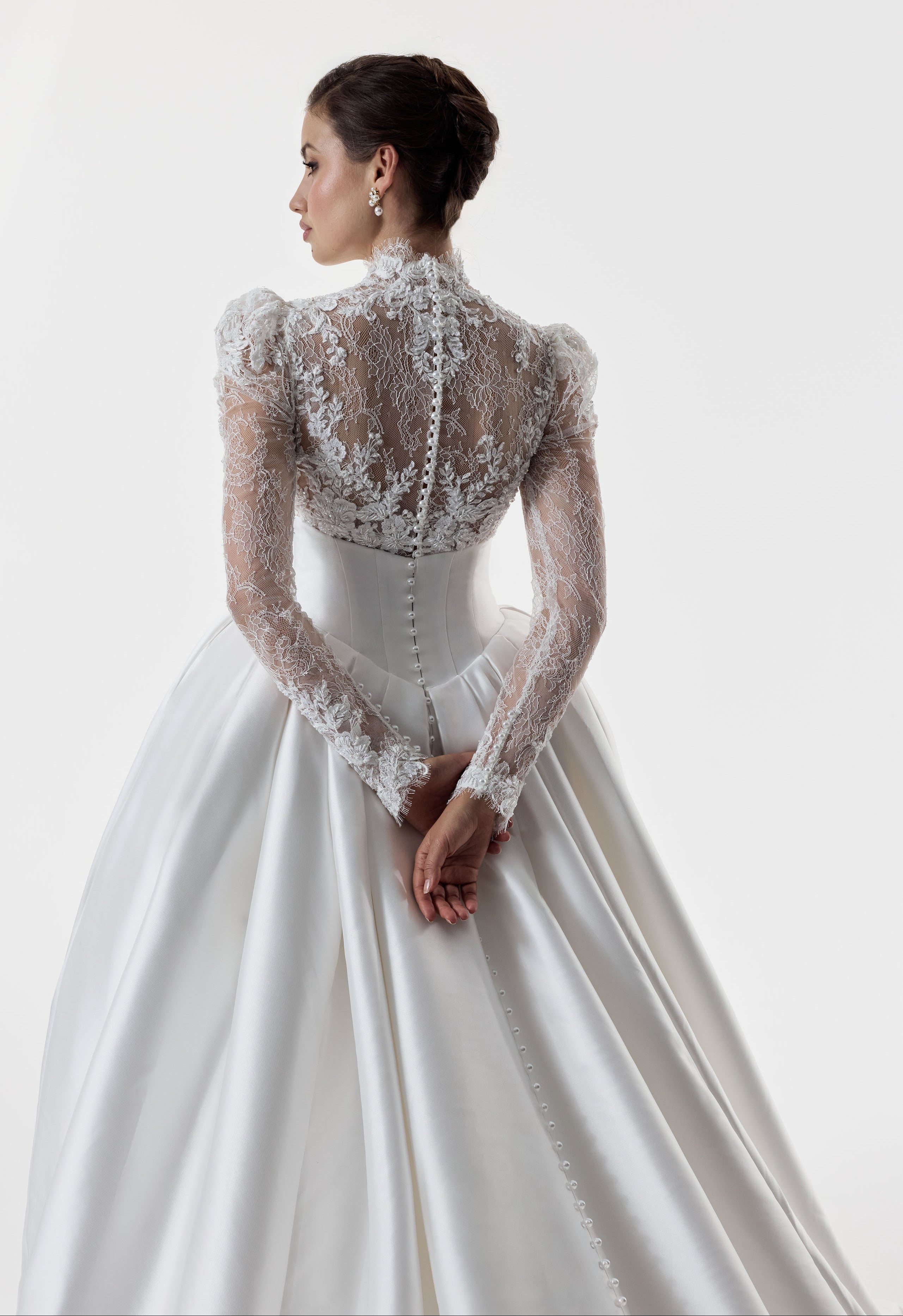 high neck encrusted lace long sleeve bodice with corset and basque waist with full silk mikado A-line ballgown skirt with pearl buttons