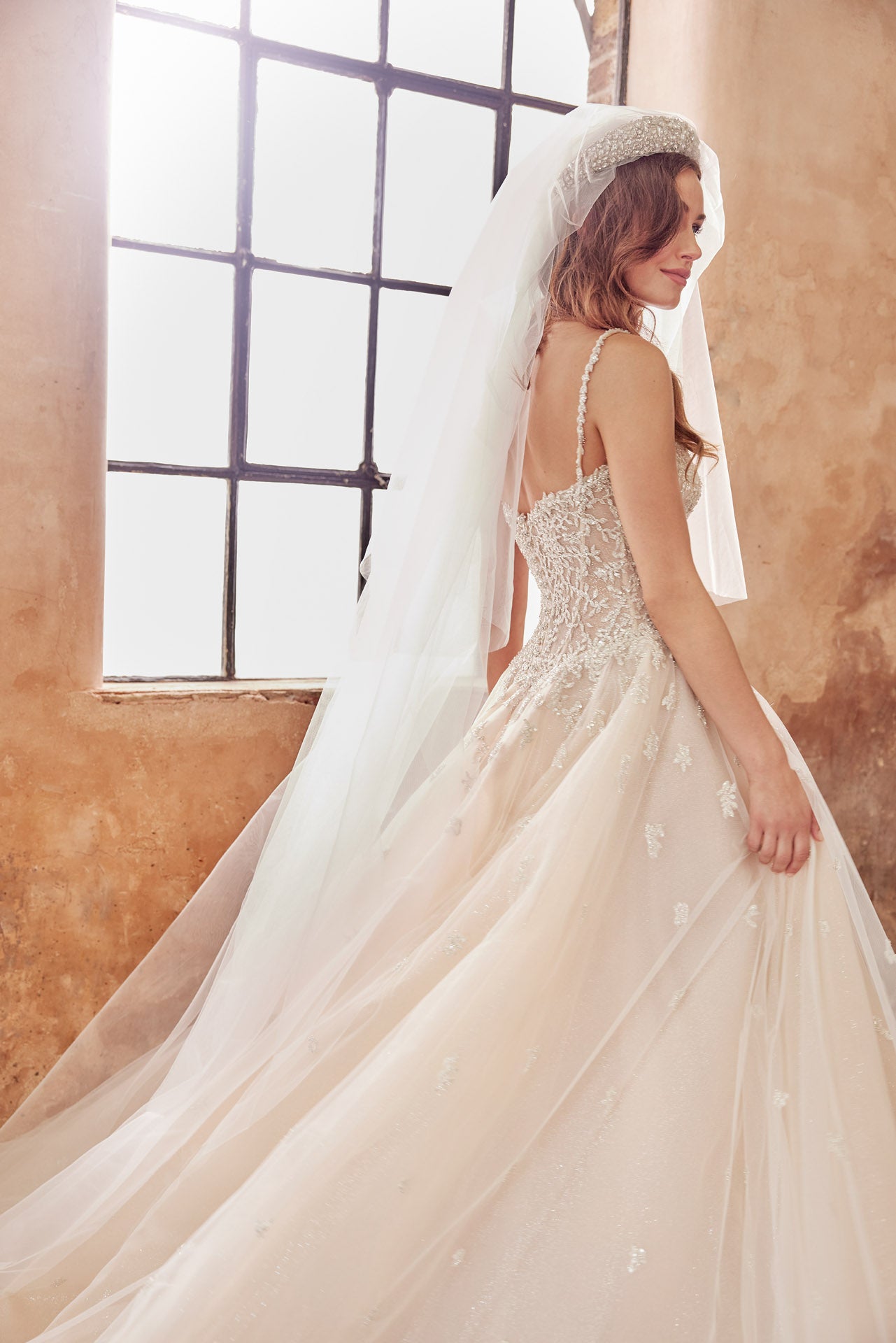Embellished princess gown, metallic beaded lace bodice and beaded straps. Full skirt with crystal buttons on back.