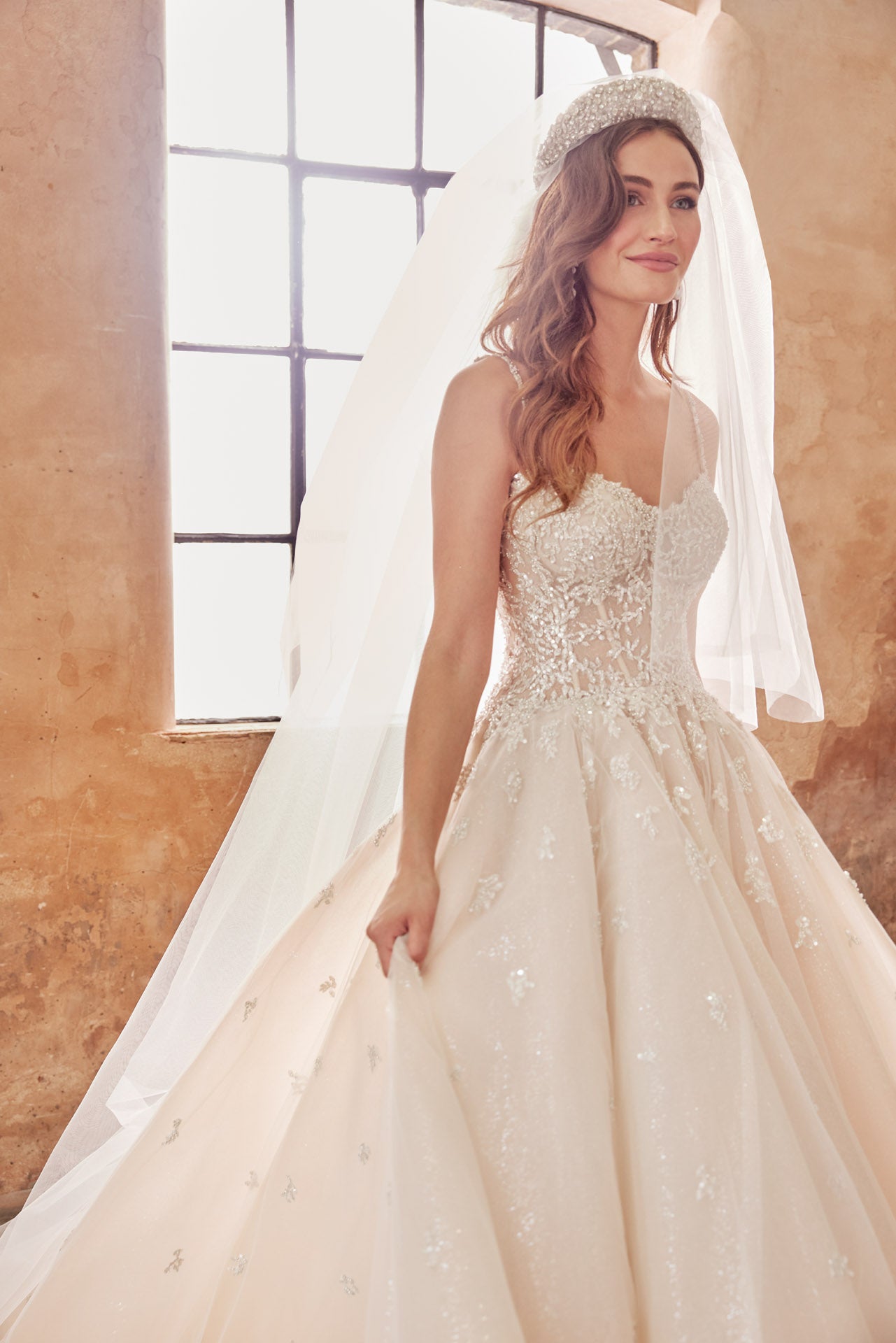 Embellished princess gown, metallic beaded lace bodice and beaded straps. Full skirt with crystal buttons on back.