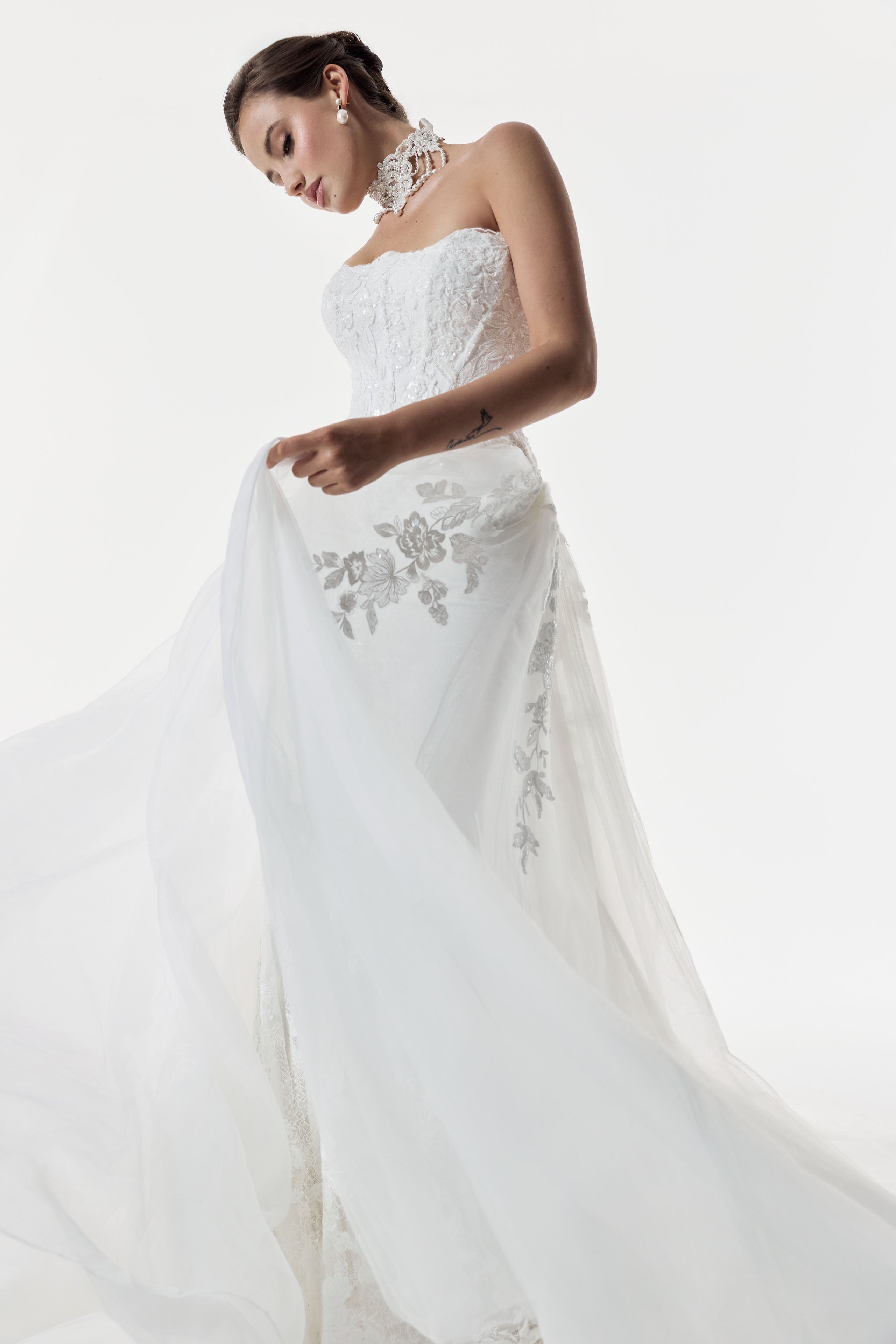 strapless scoop neckline embellished lace applique layered over Chantilly lace corset bodice basque waist with a detachable fitted skirt and choker