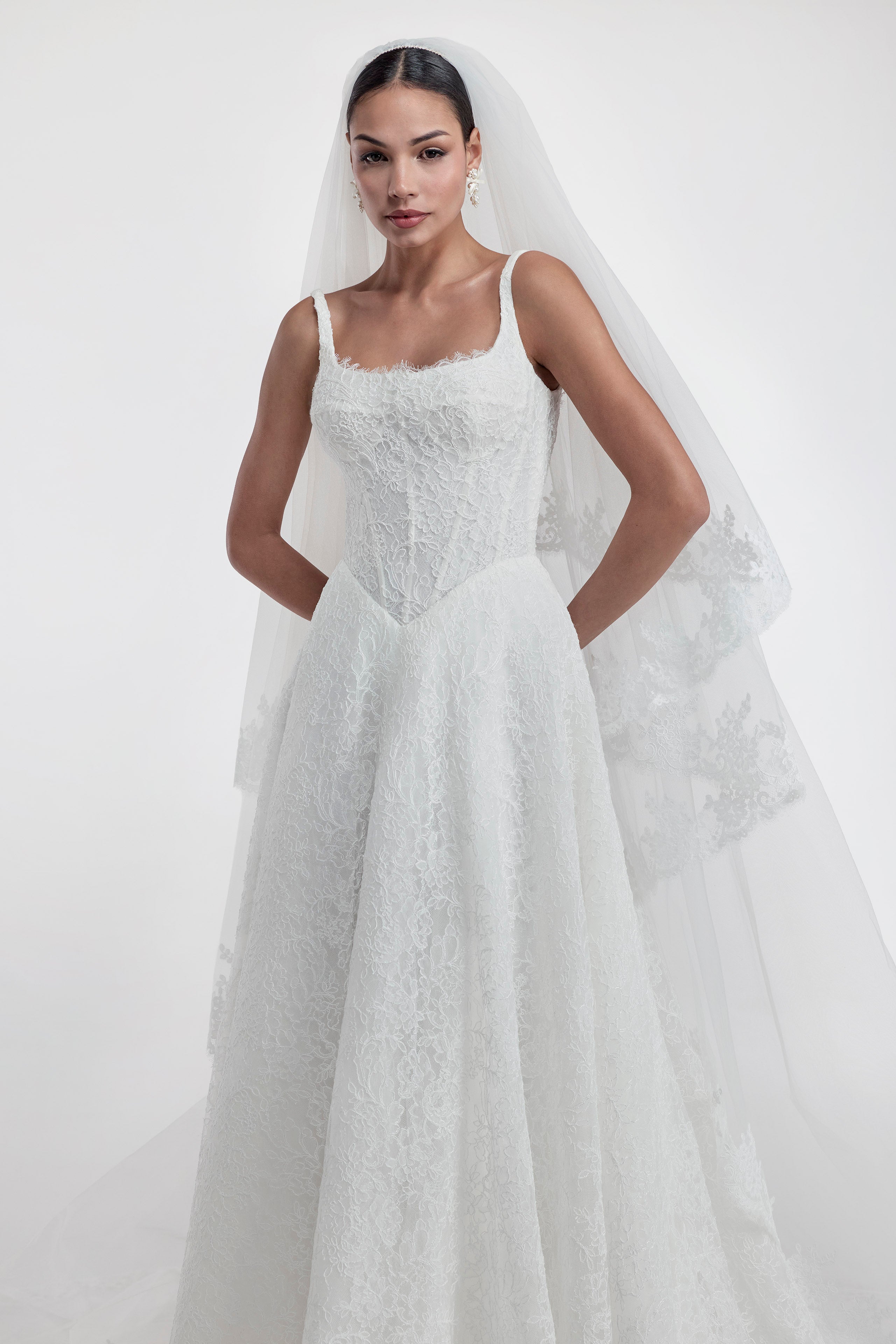 lace square neckline with basque waist and corset and A-line skirt with lace veil