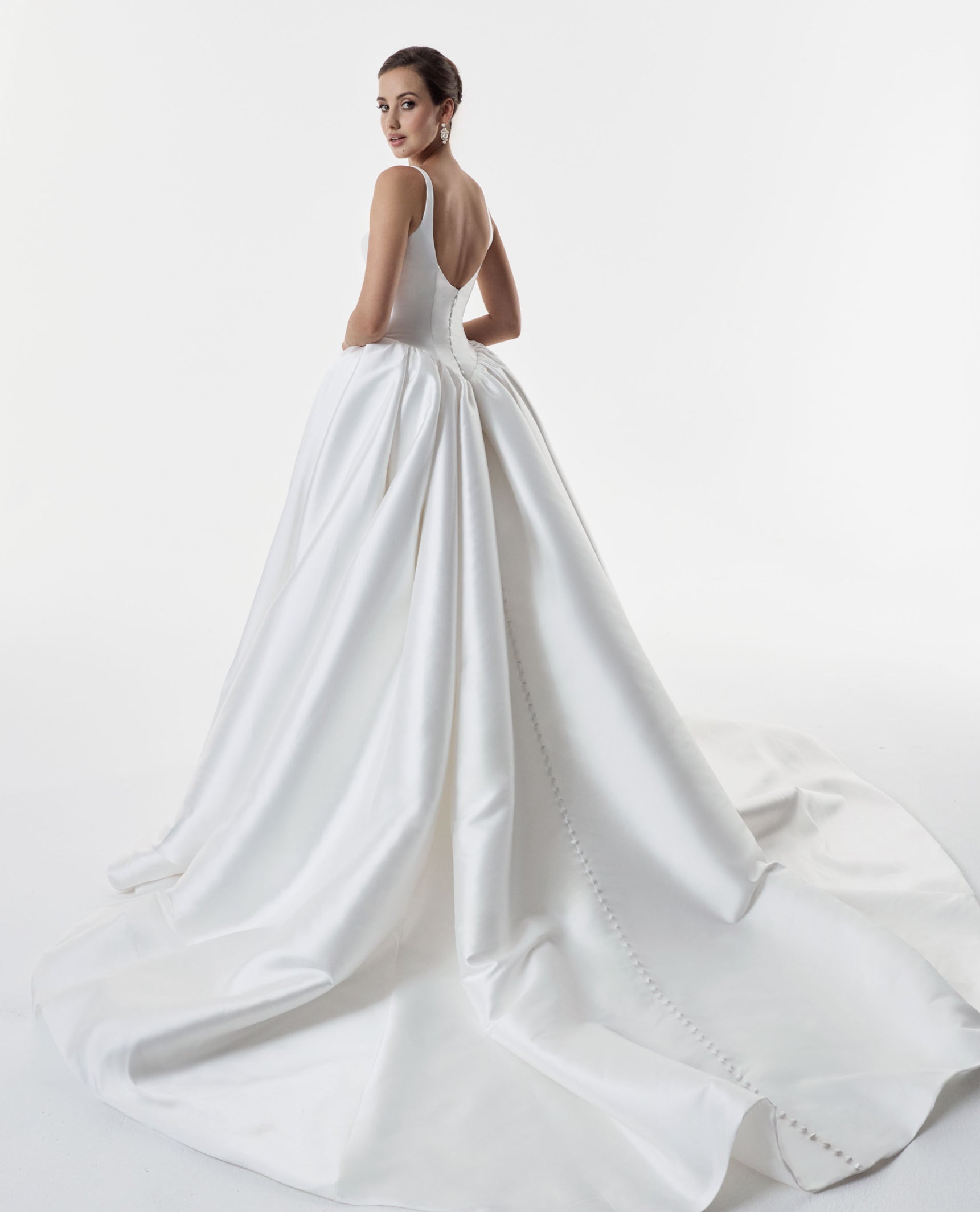 square and scoop strap neckline with a flattering basque waist corset and ballgown A-line skirt with low back and pearl buttons