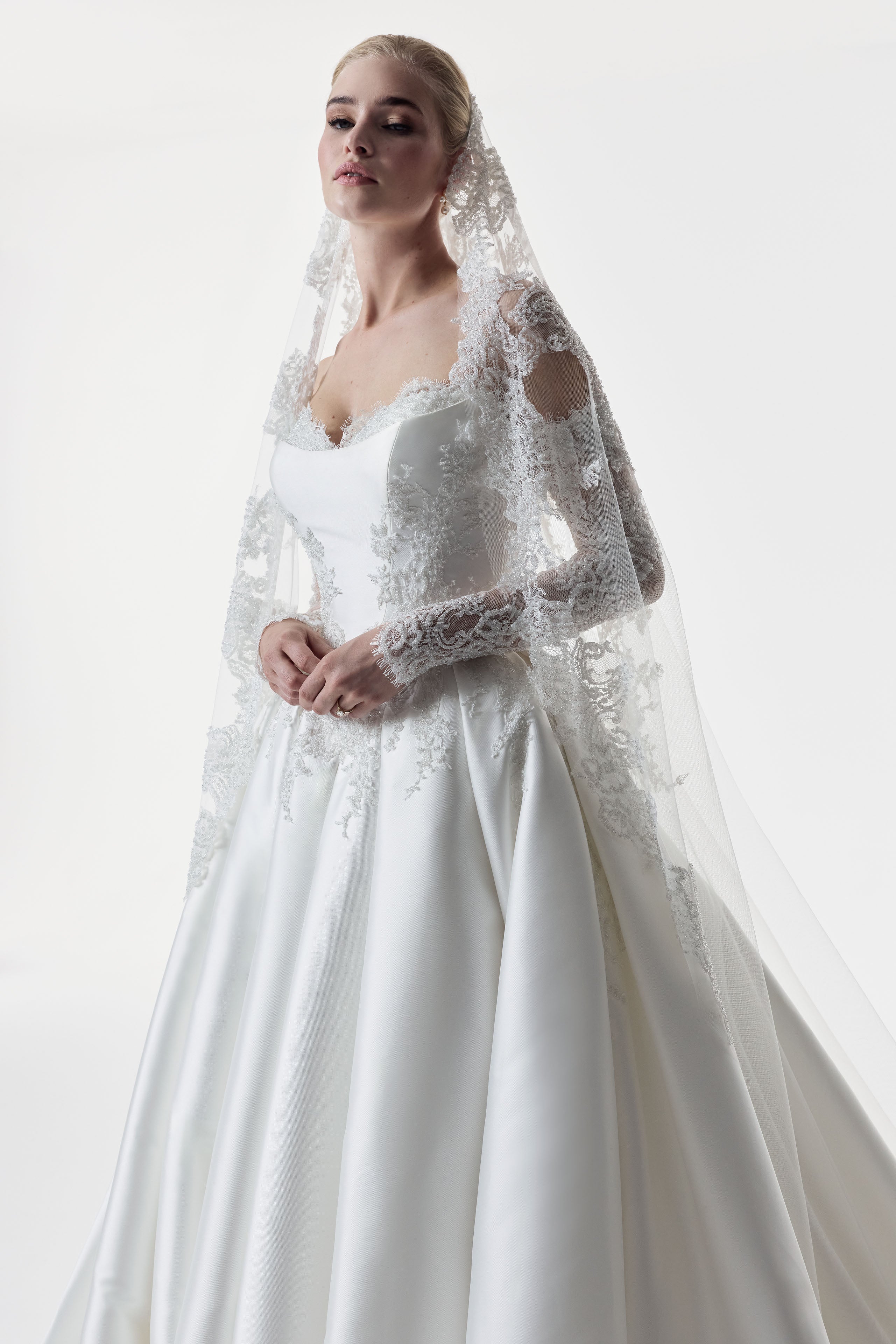 sweetheart neckline with silk Mikado and beaded lace with a basque waist corset and full A-line ballgown skirt with matching detachable lace sleeves and veil