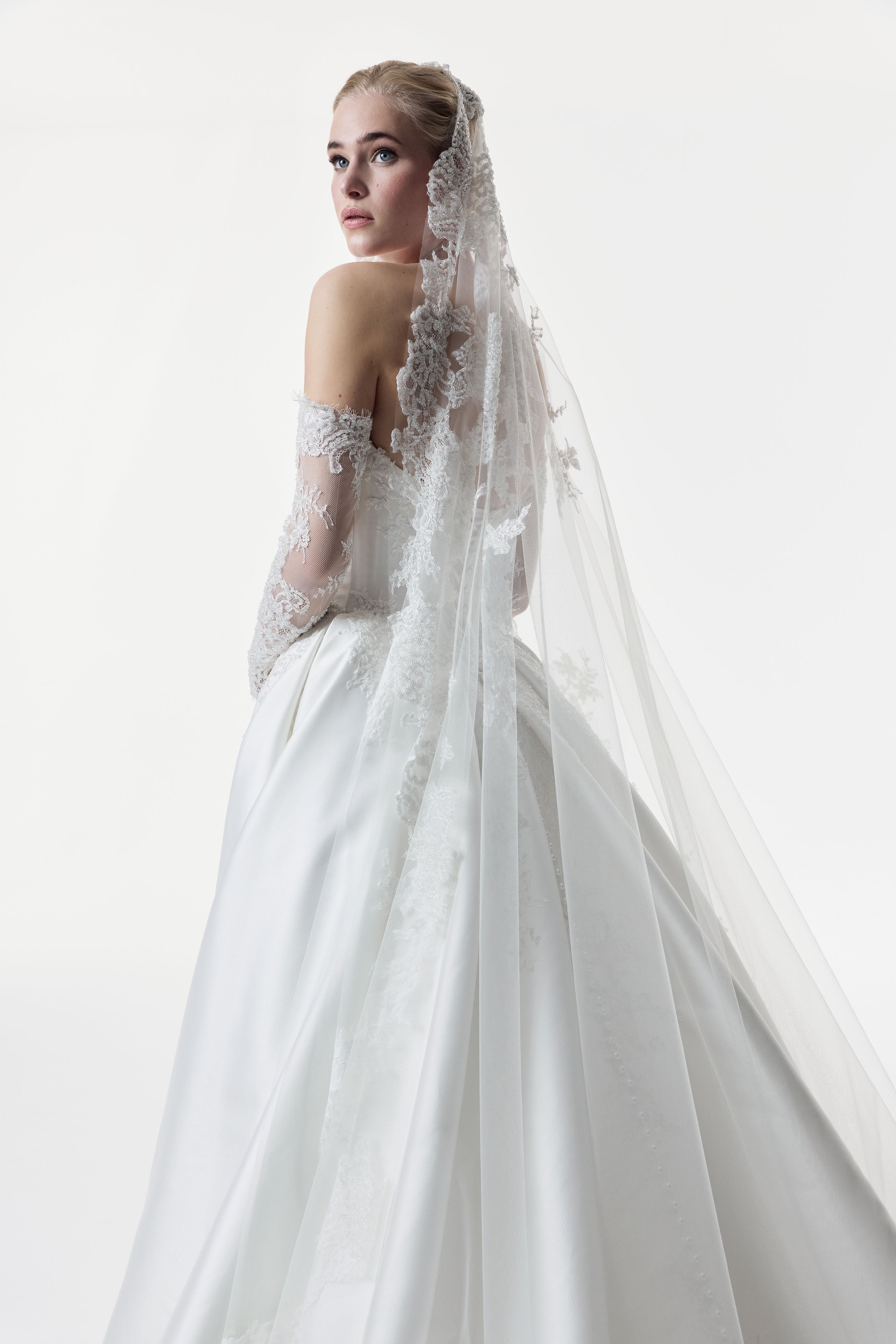 sweetheart neckline with silk Mikado and beaded lace with a basque waist corset and full A-line ballgown skirt with matching detachable sleeves and lace veil