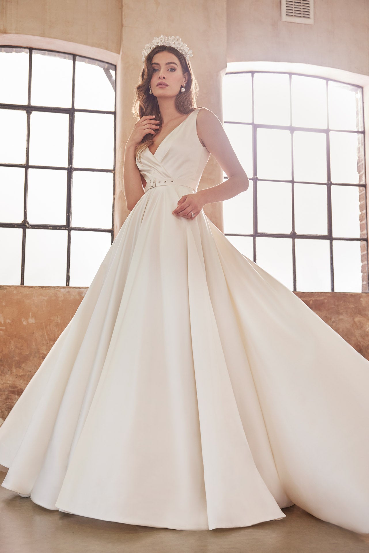Full skirted a-line gown with flattering neckline, detachable belt and bow. Sumptuous satin with inner corset, full circle skirt with concealed pockets.