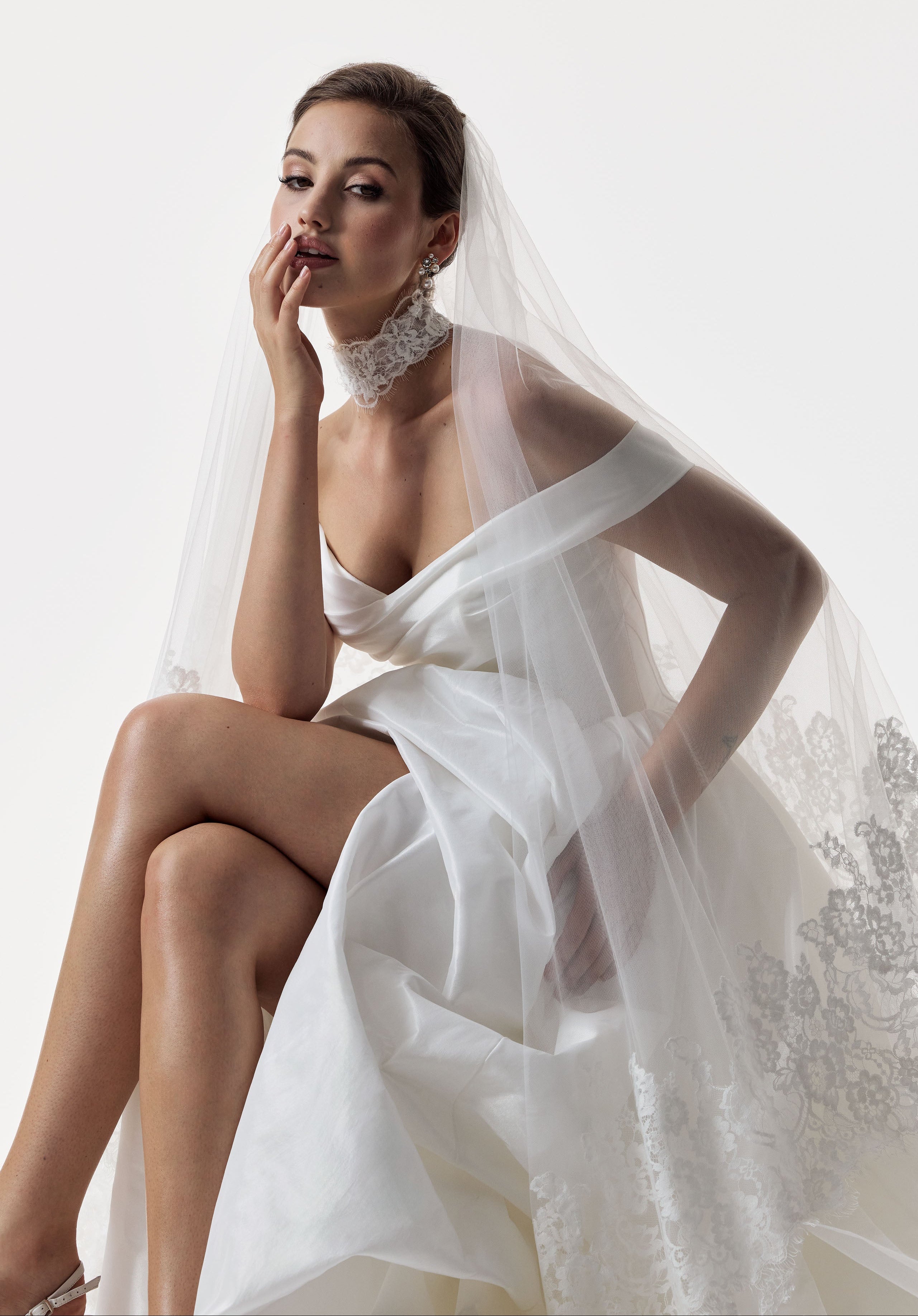 classic ivory bardot neckline and corset basque waist and ruched pick-up skirt leg slit detailing