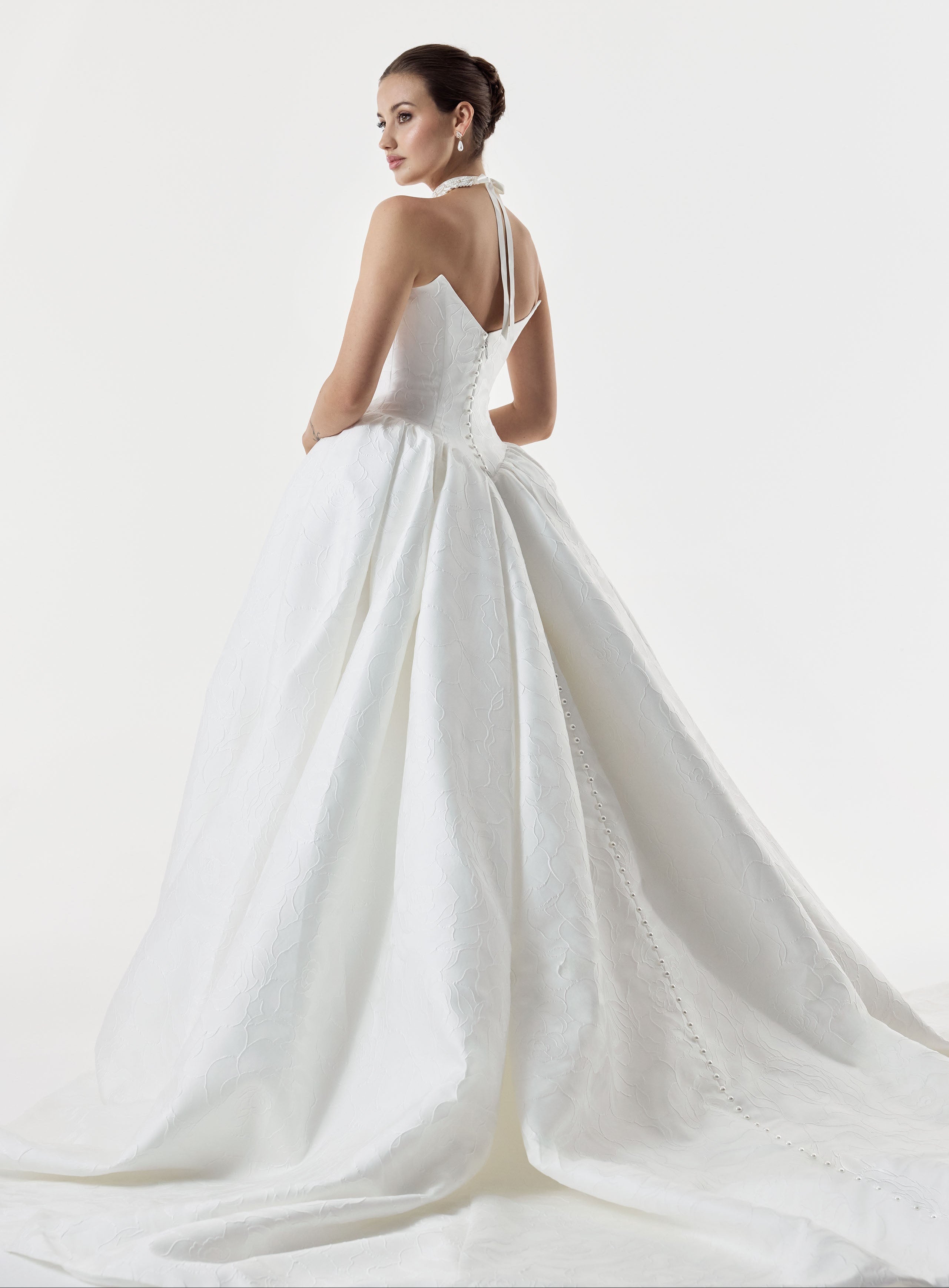 strapless cat eye neckline with sculptural structured pleated bodice and a basque waist and full A-line ballgown skirt