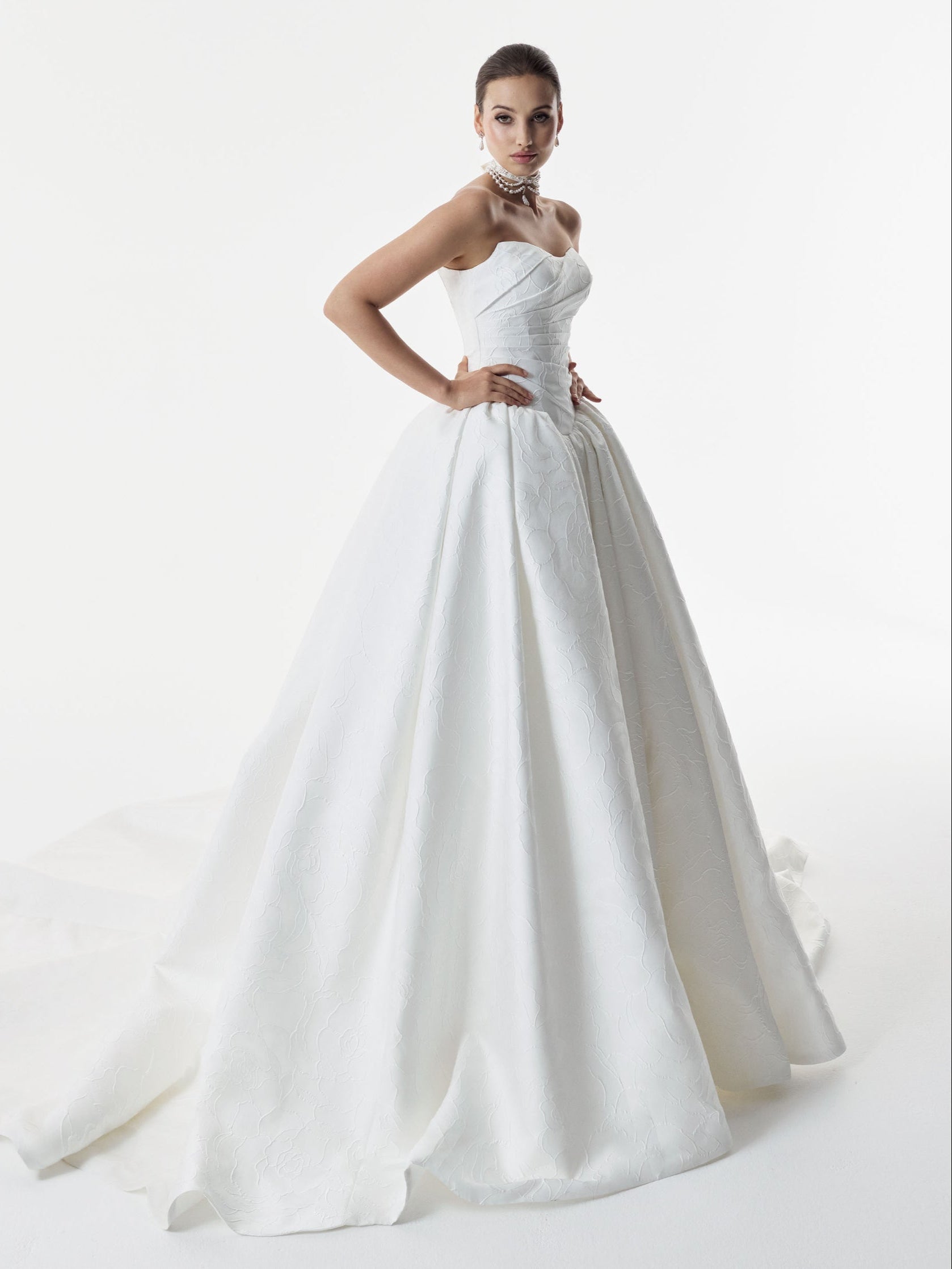 strapless cat eye neckline with sculptural structured pleated bodice and a basque waist full A-line ballgown skirt