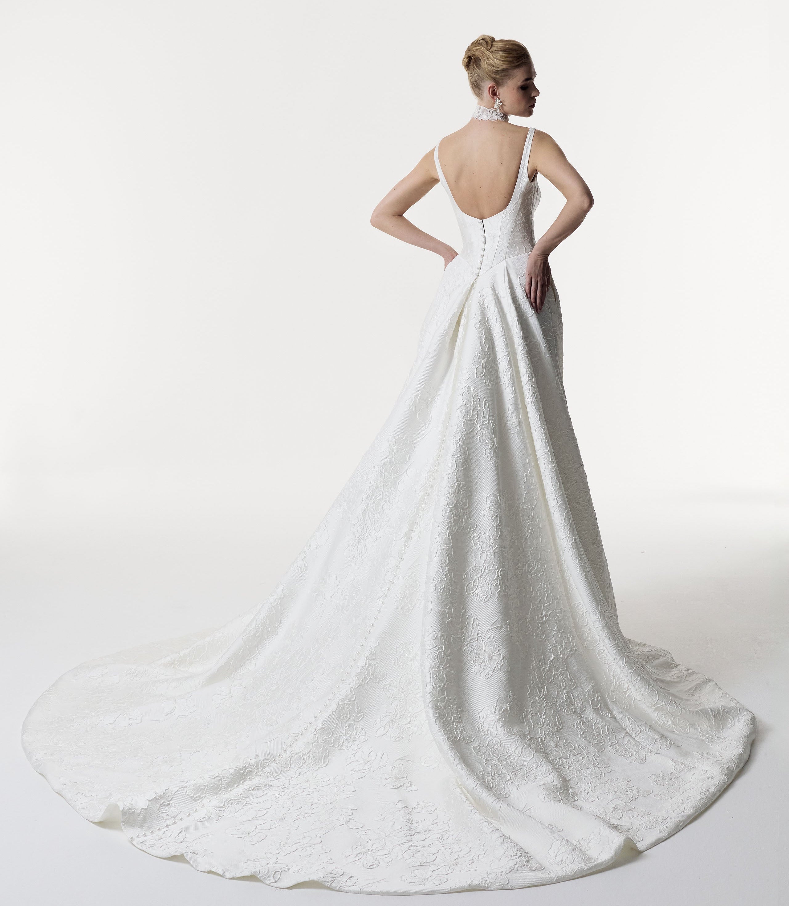 square neckline with low back and basque waist A-Line skirt in silk embossed jacquard with pearl buttons and lace choker