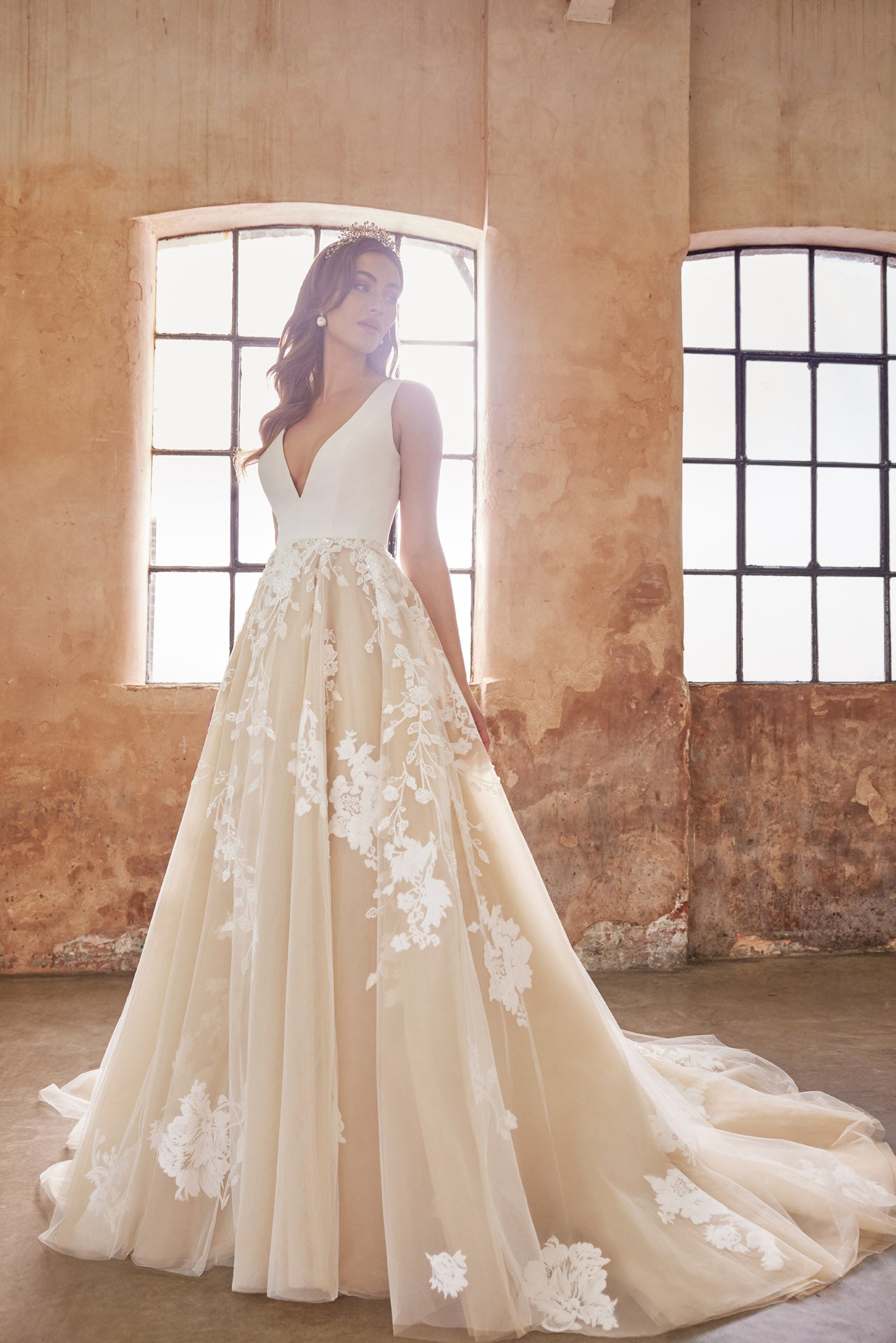 Ballgown with soft layers of tulle and floral applique lace on skirt, crepe v-neck bodice and key-hole back.