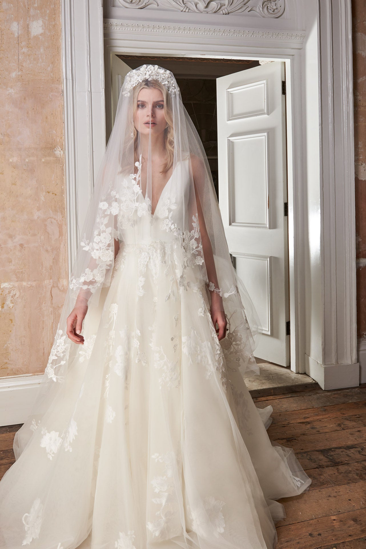Ballgown with soft layers of tulle and floral applique lace on skirt, crepe v-neck bodice and key-hole back.