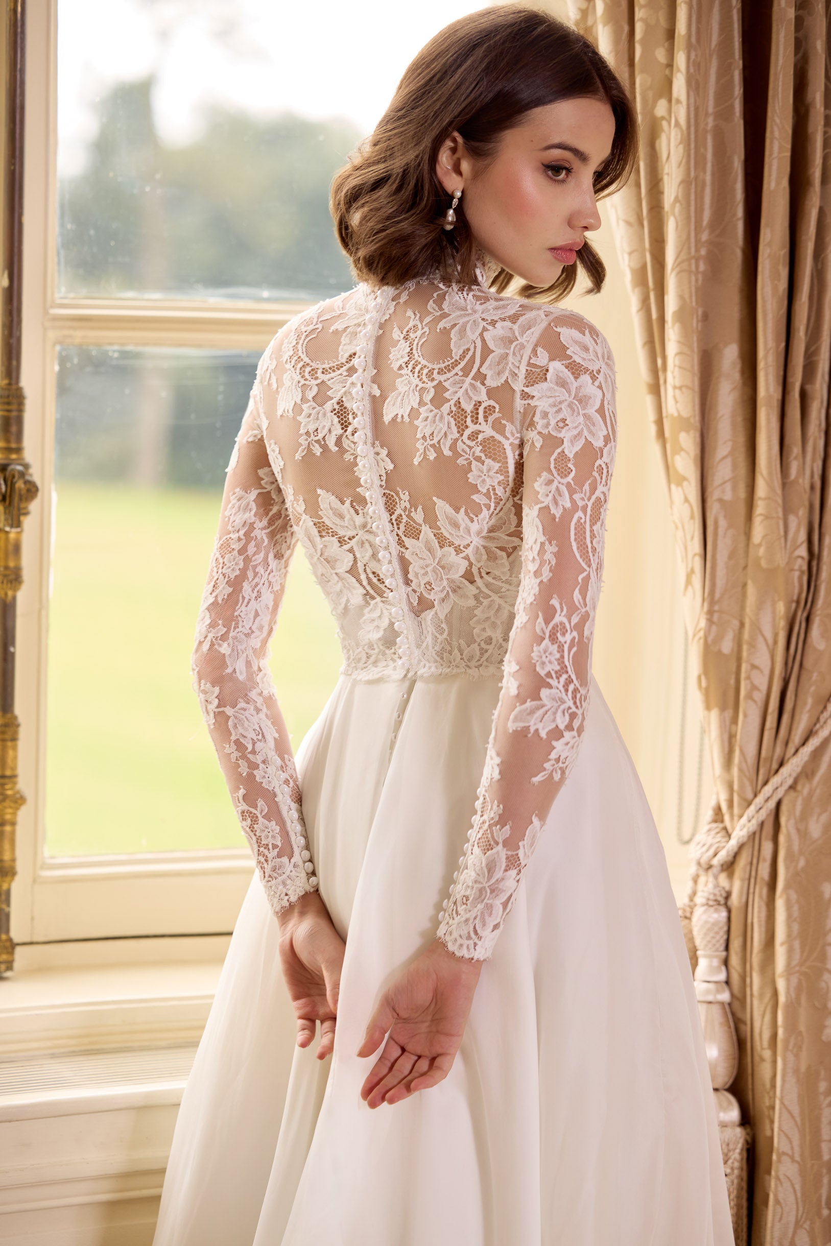 high neck, sweetheart neckline long sleeved lace corset bodice with a flattering plunge neckline and button back with a silk organza A-line skirt