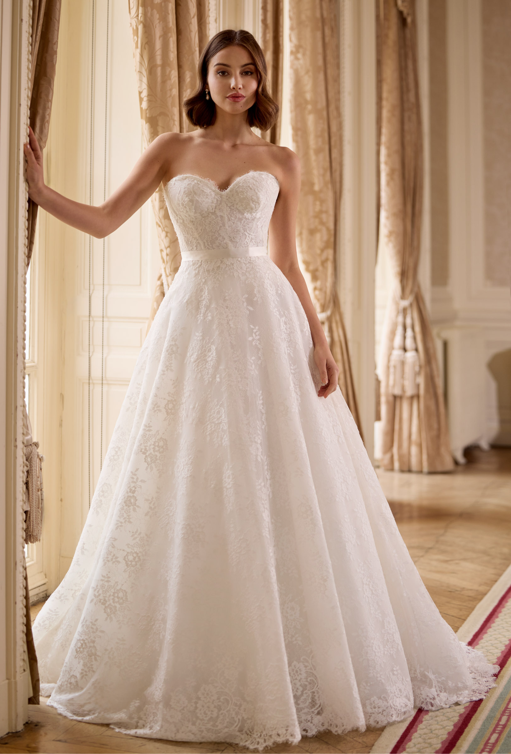 strapless French Chantilly A-line gown with intricate pearl button