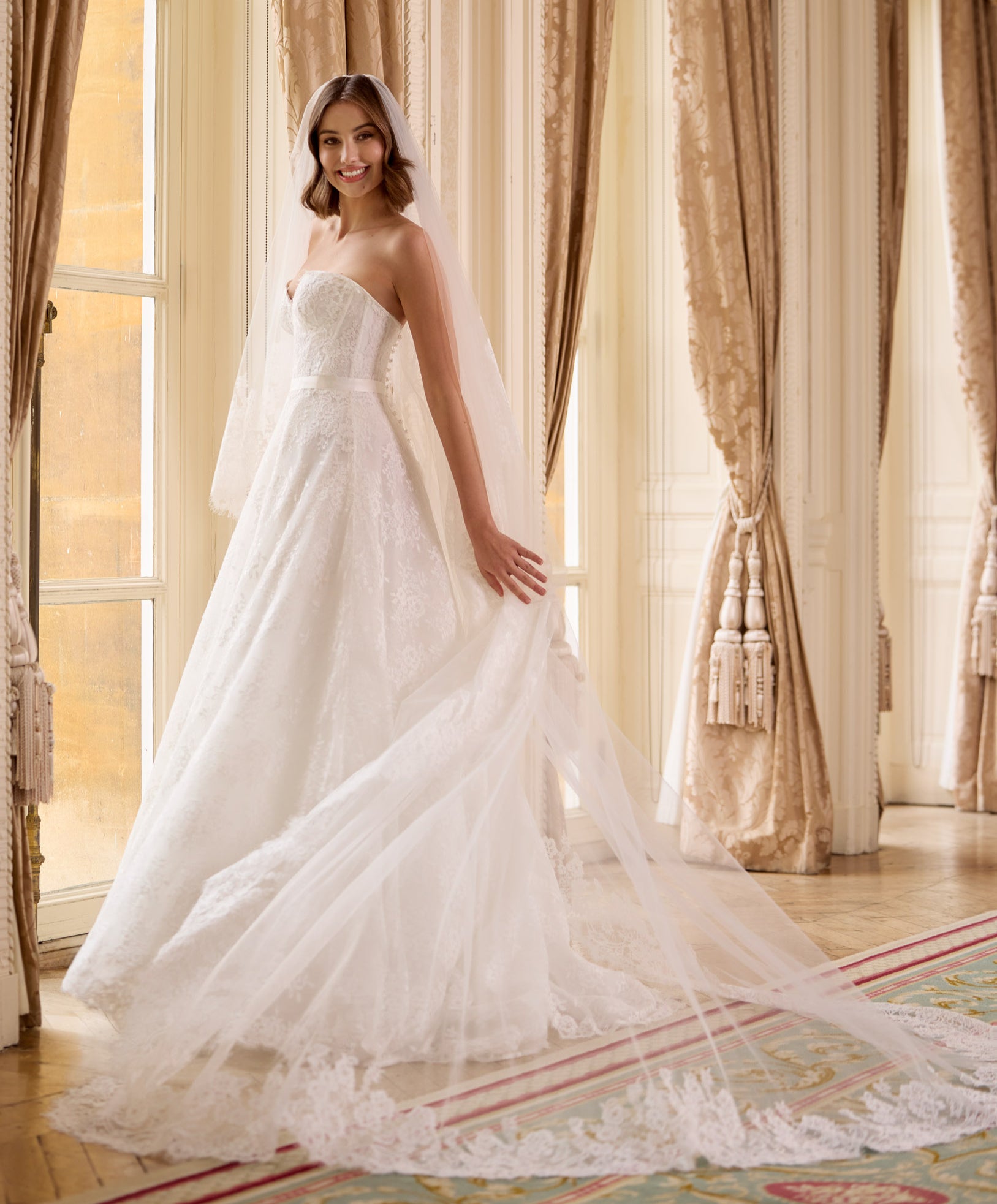 strapless French Chantilly A-line gown with intricate pearl button