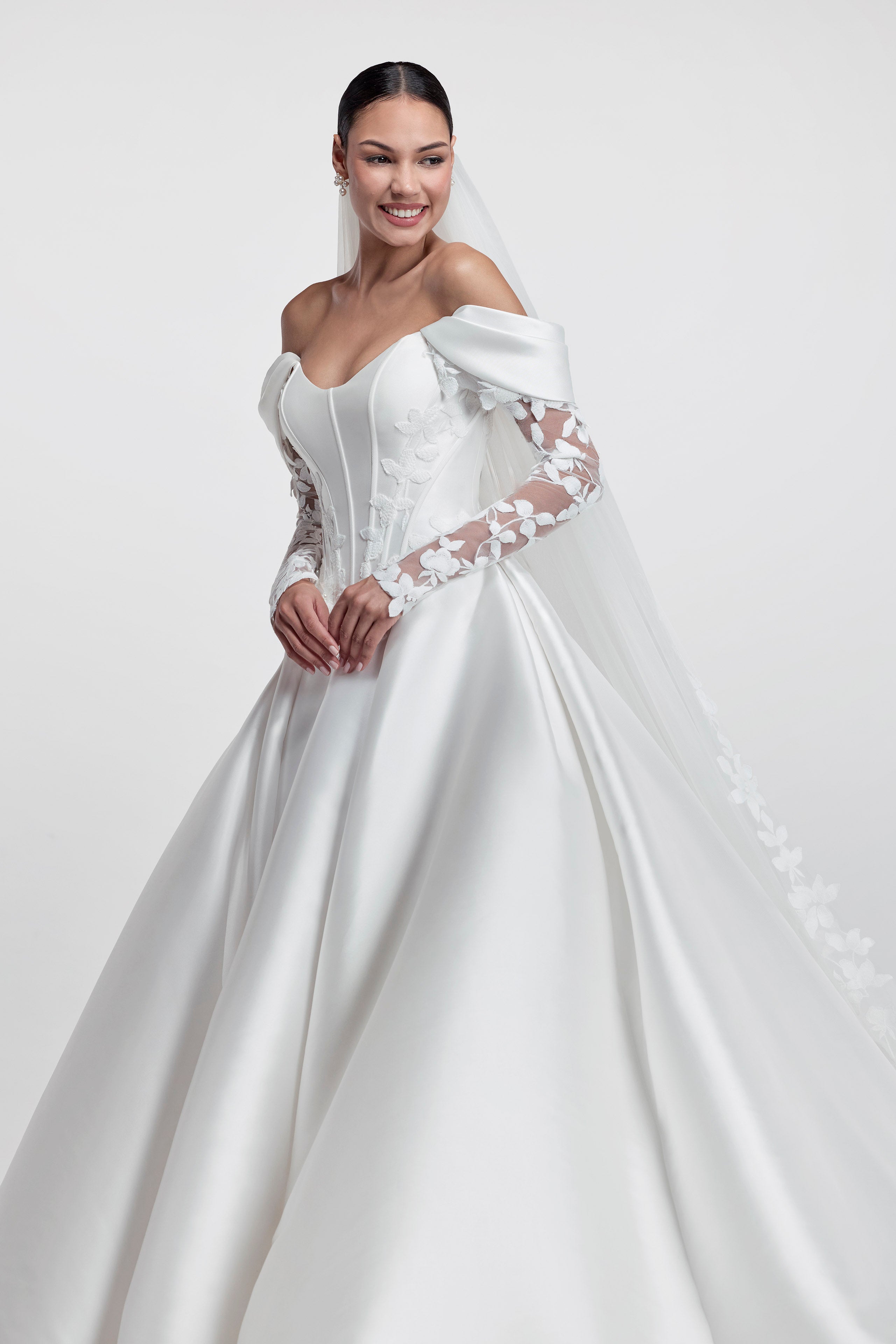 Strapless cat eye neckline with V basque dropped waist corset and A-line skirt with floral embroidered lace applique with detachable straps and lace sleeves