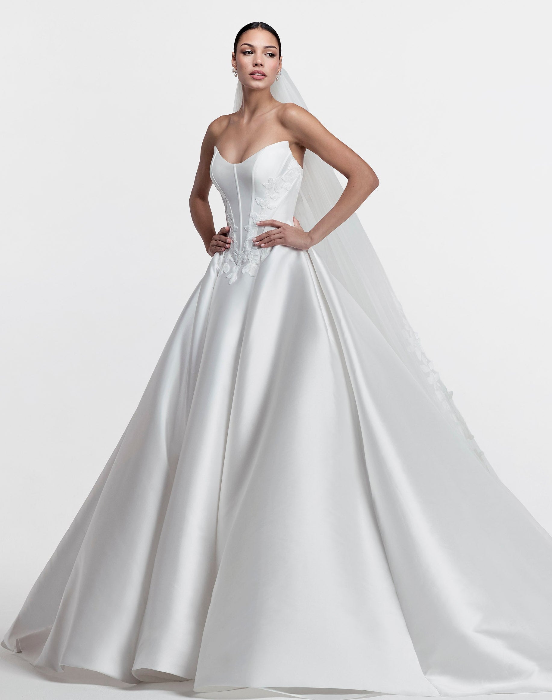 Strapless cat eye neckline with V basque dropped waist corset and A-line skirt with floral embroidered lace applique